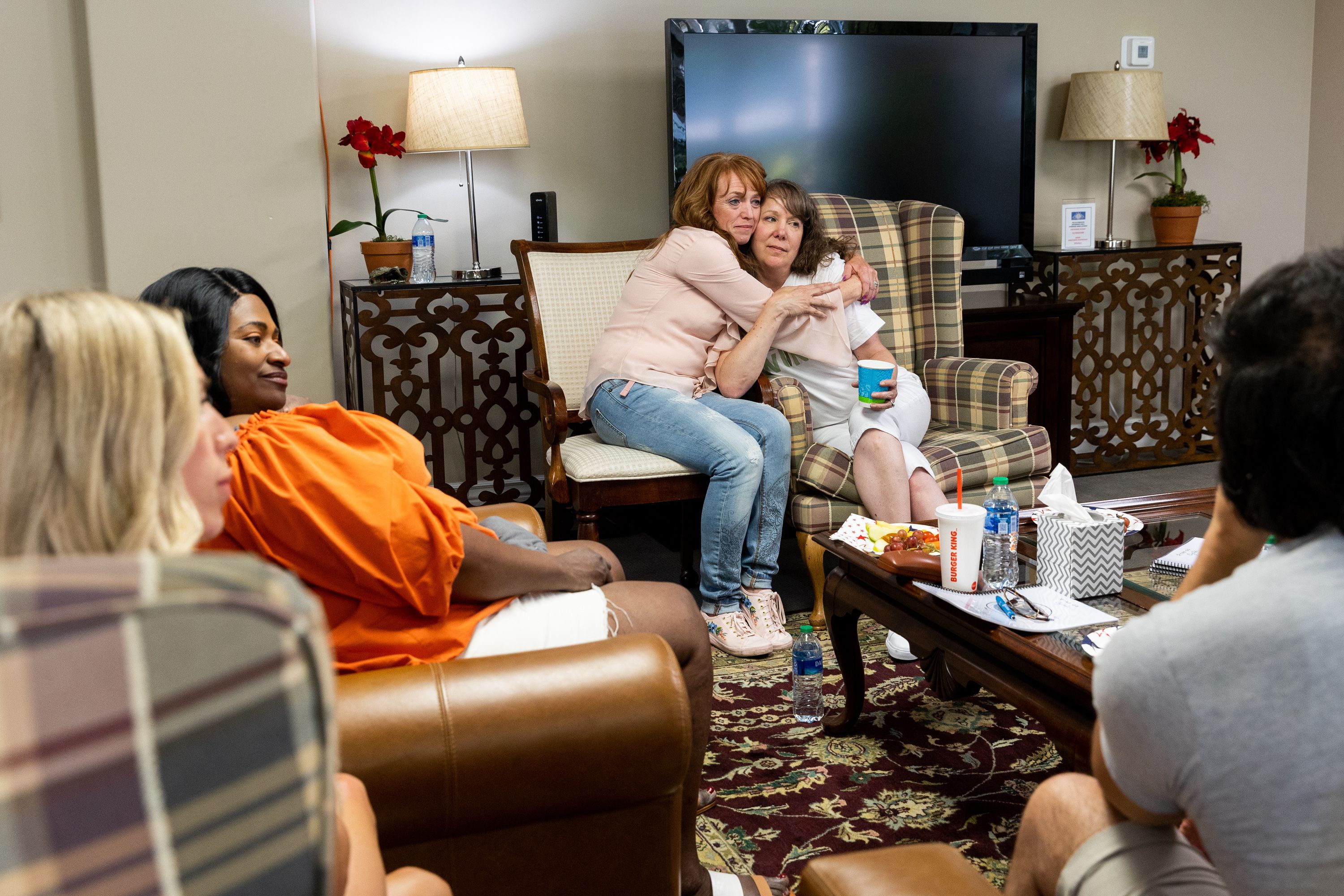 Left to right, Kelli Christensen hugs Tasha Cram at the Hug Tour stop at the Presidential Club Condos in Salt Lake City on July 8. After losing her twin at age 4, Cram is bringing together other twinless twins for support and healing.