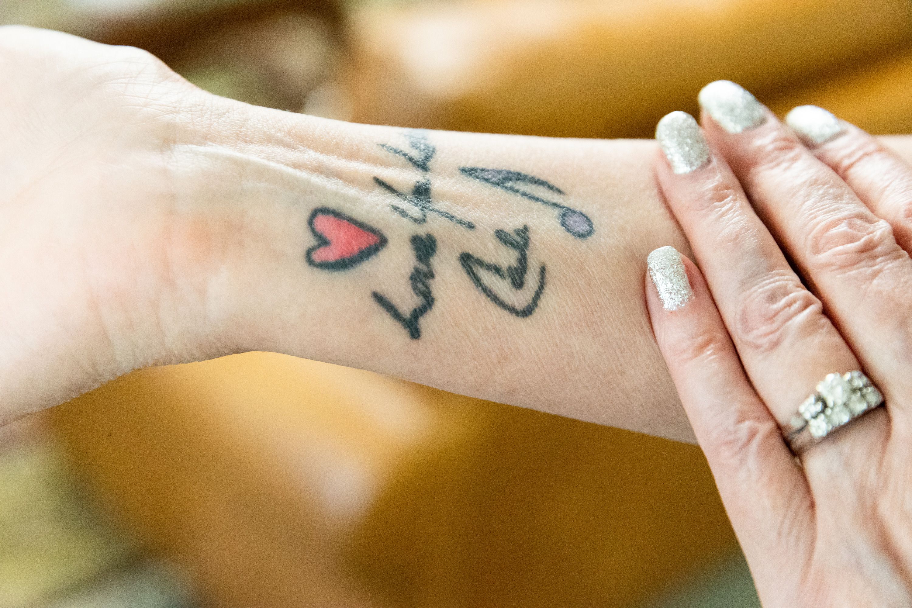 Charla Haley shows the tattoo she got of her twin’s handwriting after she passed away, at the Presidential Club Condos in Salt Lake City on July 8. After losing her own twin, Haley has built a friendship with “Twinful Twin” Tasha Cram.