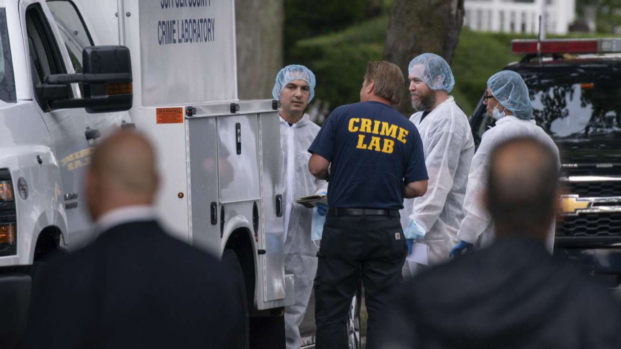 Crime laboratory officers on New York's Long Island arrive to help investigate a long-unsolved string of killings, known as the Gilgo Beach murders, Friday in Massapequa Park, N.Y.