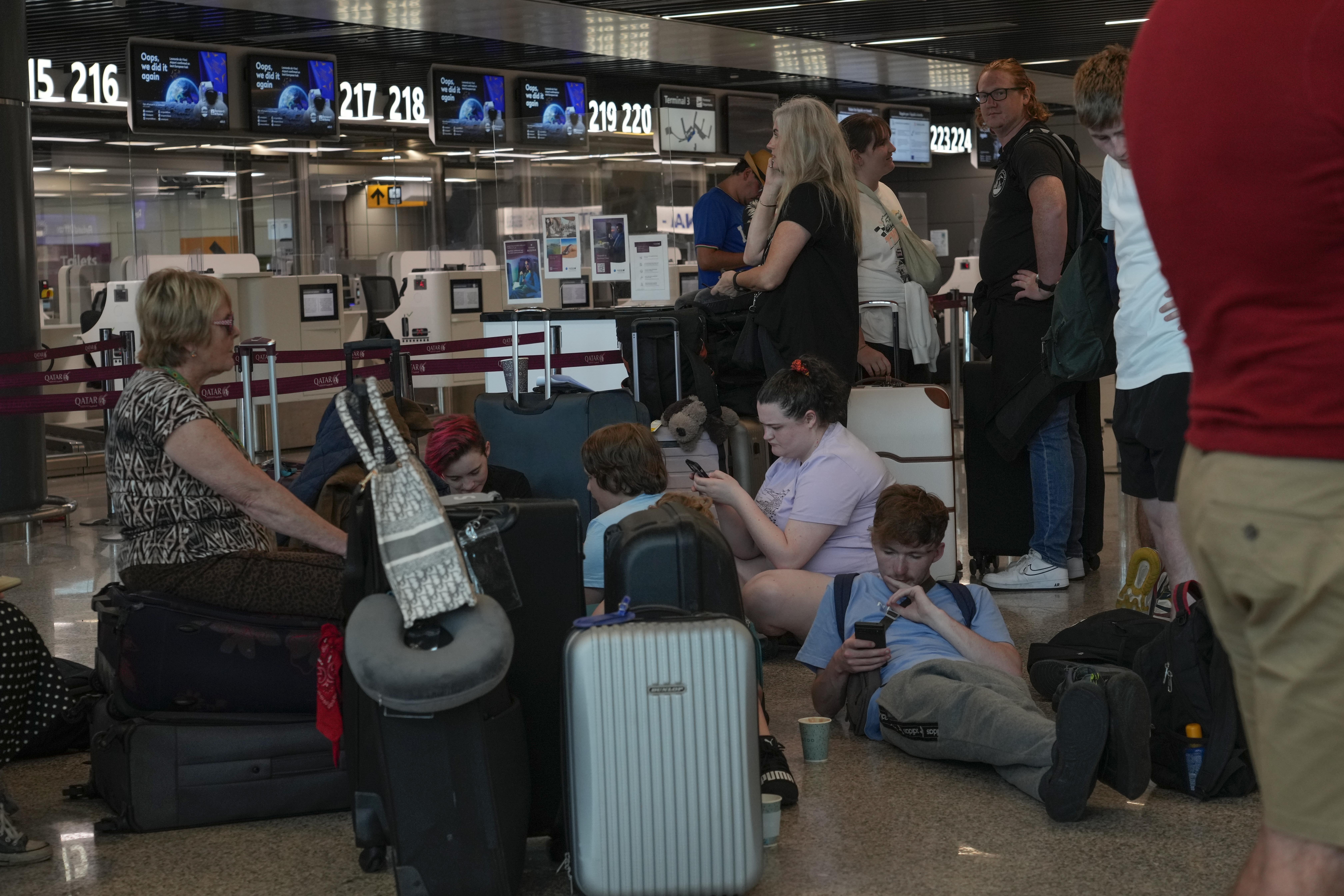 Passengers at Rome's Fiumicino International airport in Italy, wait Saturday for the check-in of their flights during a nationwide strike of airports ground staff and check-in services.