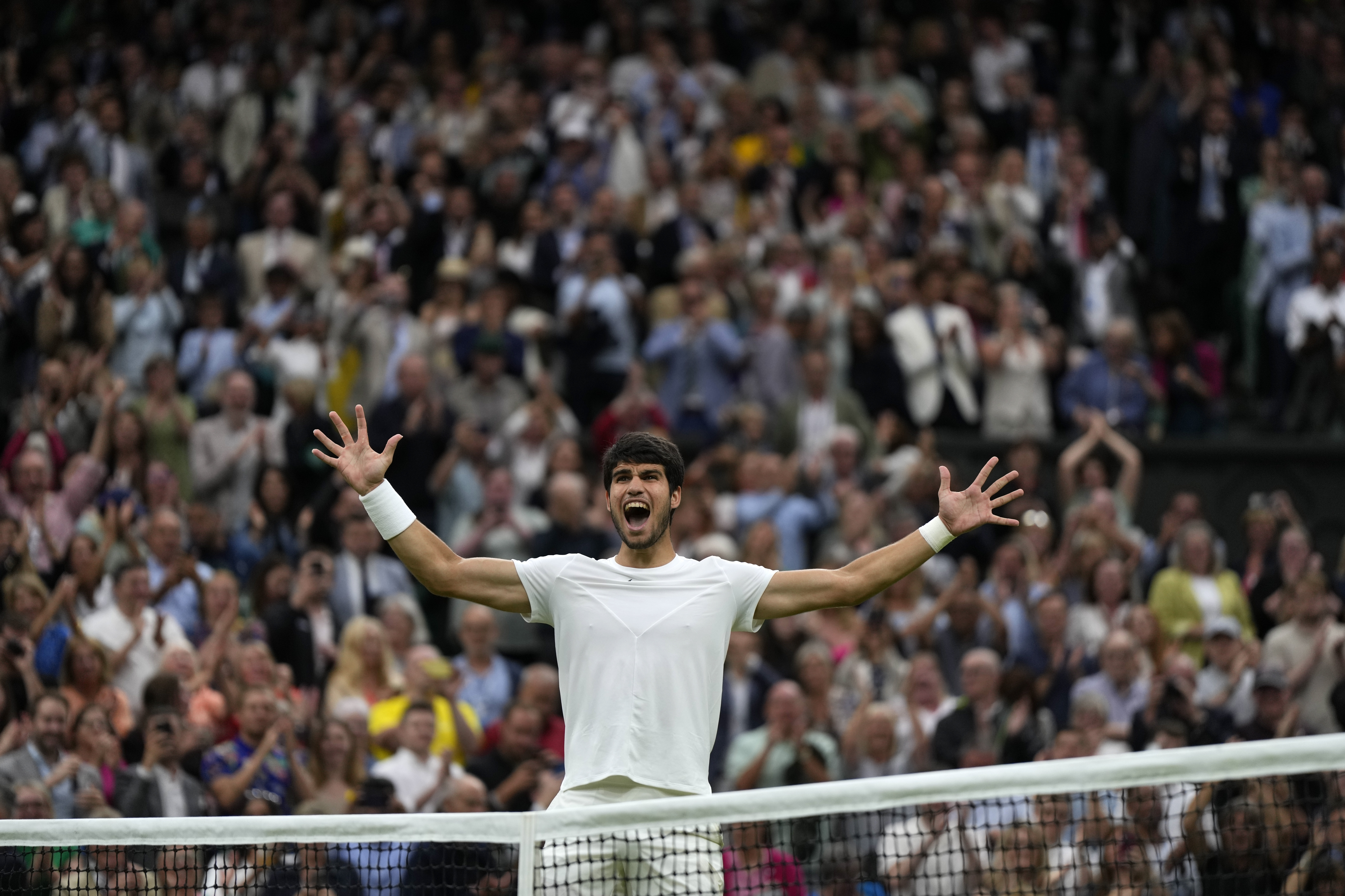 Spain's Carlos Alcaraz celebrates after beating Russia's Daniil Medvedev to win their men's singles semifinal match on day twelve of the Wimbledon tennis championships in London, Friday, July 14, 2023. 