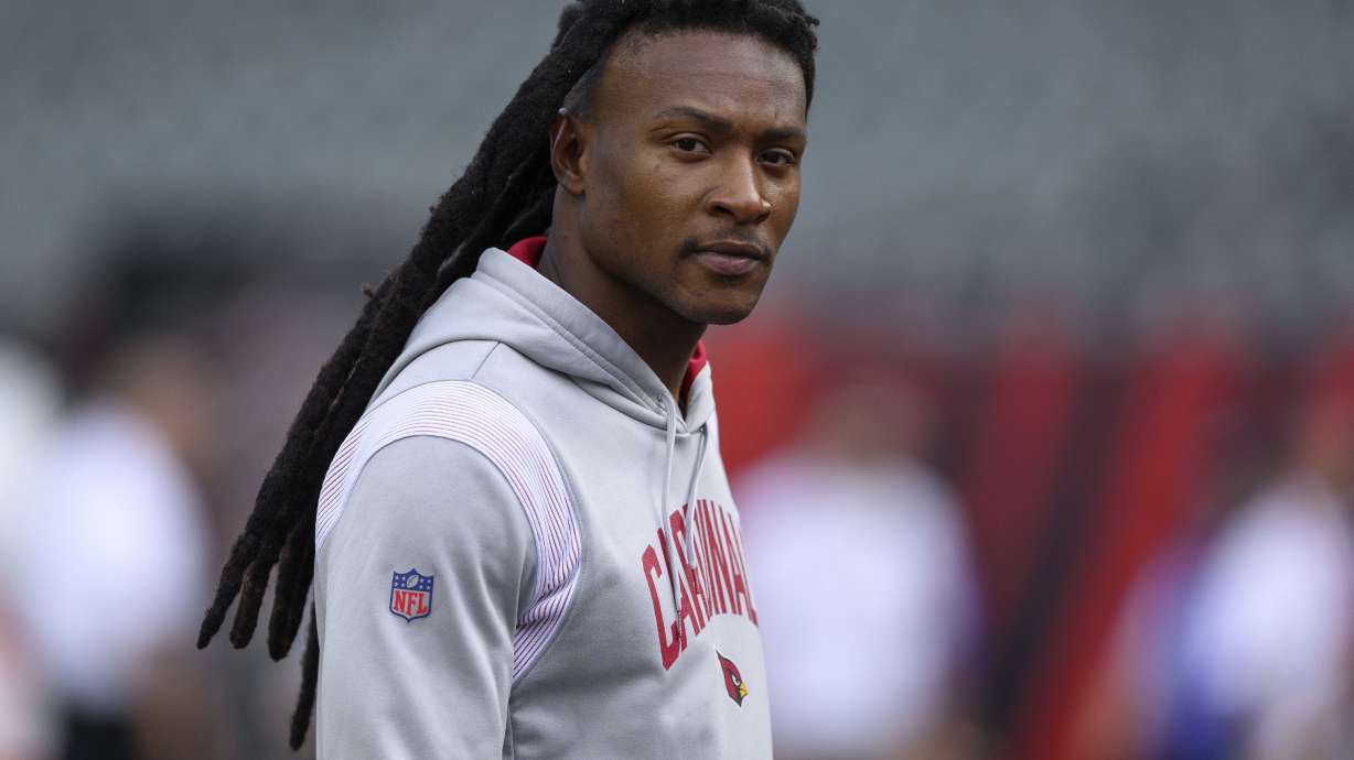 FILE - Arizona Cardinals wide receiver DeAndre Hopkins walks on the field before an NFL football game against the Cincinnati Bengals, Aug. 12, 2022, in Cincinnati. The Tennessee Titans hope they have filled their major need at wide receiver with three-time All-Pro wide receiver Hopkins by agreeing to terms on a two-year deal worth $26 million with incentives that could push that to $32 million, a person familiar with the agreement said Sunday, July 16, 2023.