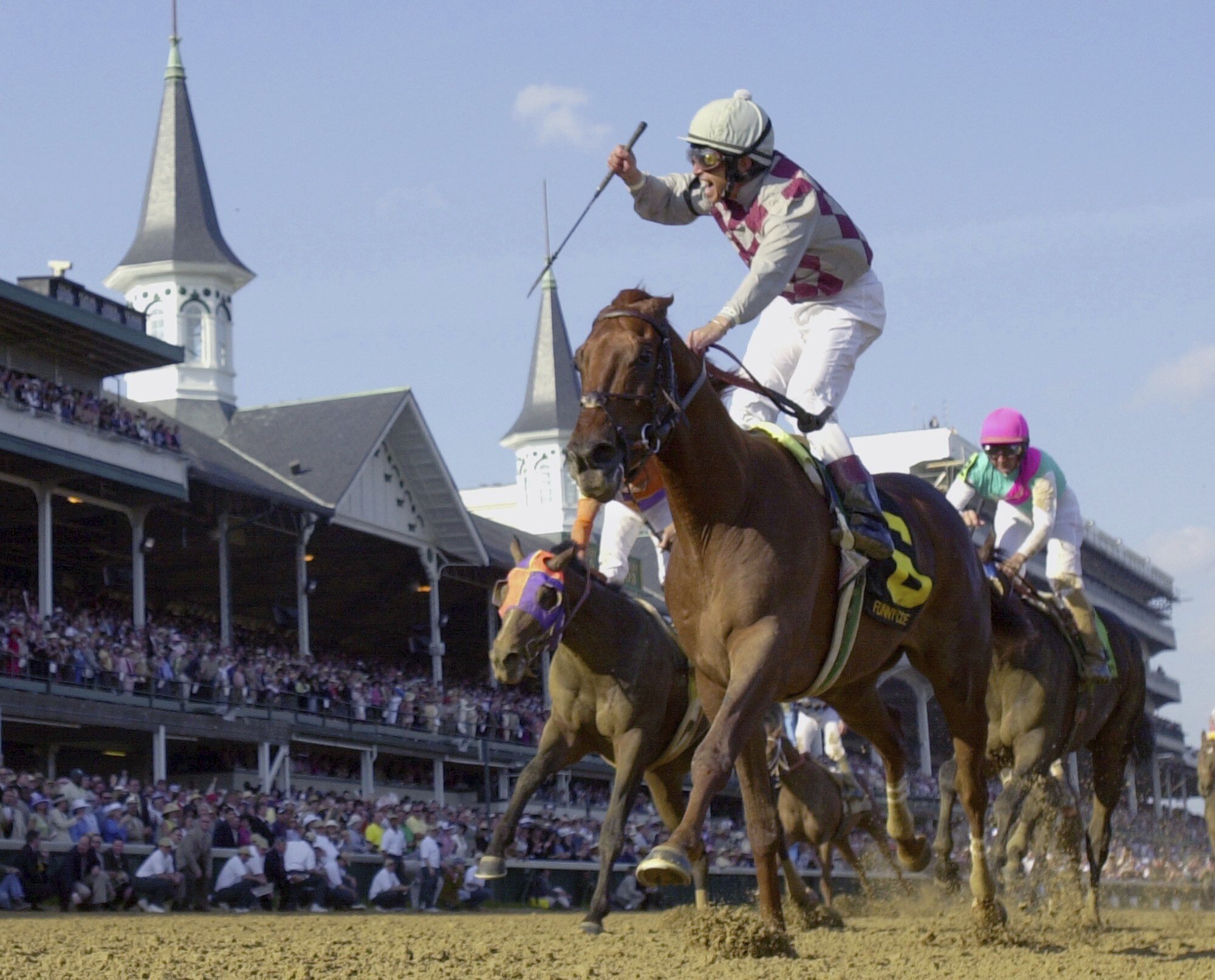 FILE - Jockey Jose Santos celebrates aboard Funny Cide after crossing the finish line to win the 129th running of the Kentucky Derby at Churchill Downs on May 3, 2003, in Louisville, Ky. Cide, the “Gutsy Gelding” who became a fan favorite after winning the Kentucky Derby and Preakness in 2003, has died of complications resulting from colic on Sunday, July 16, 2023. He was 23. 