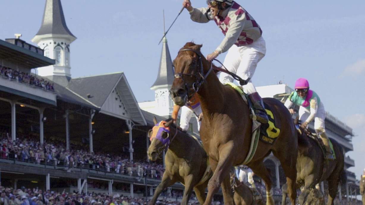 FILE - Jockey Jose Santos celebrates aboard Funny Cide after crossing the finish line to win the 129th running of the Kentucky Derby at Churchill Downs on May 3, 2003, in Louisville, Ky. Cide, the “Gutsy Gelding” who became a fan favorite after winning the Kentucky Derby and Preakness in 2003, has died of complications resulting from colic on Sunday, July 16, 2023. He was 23.