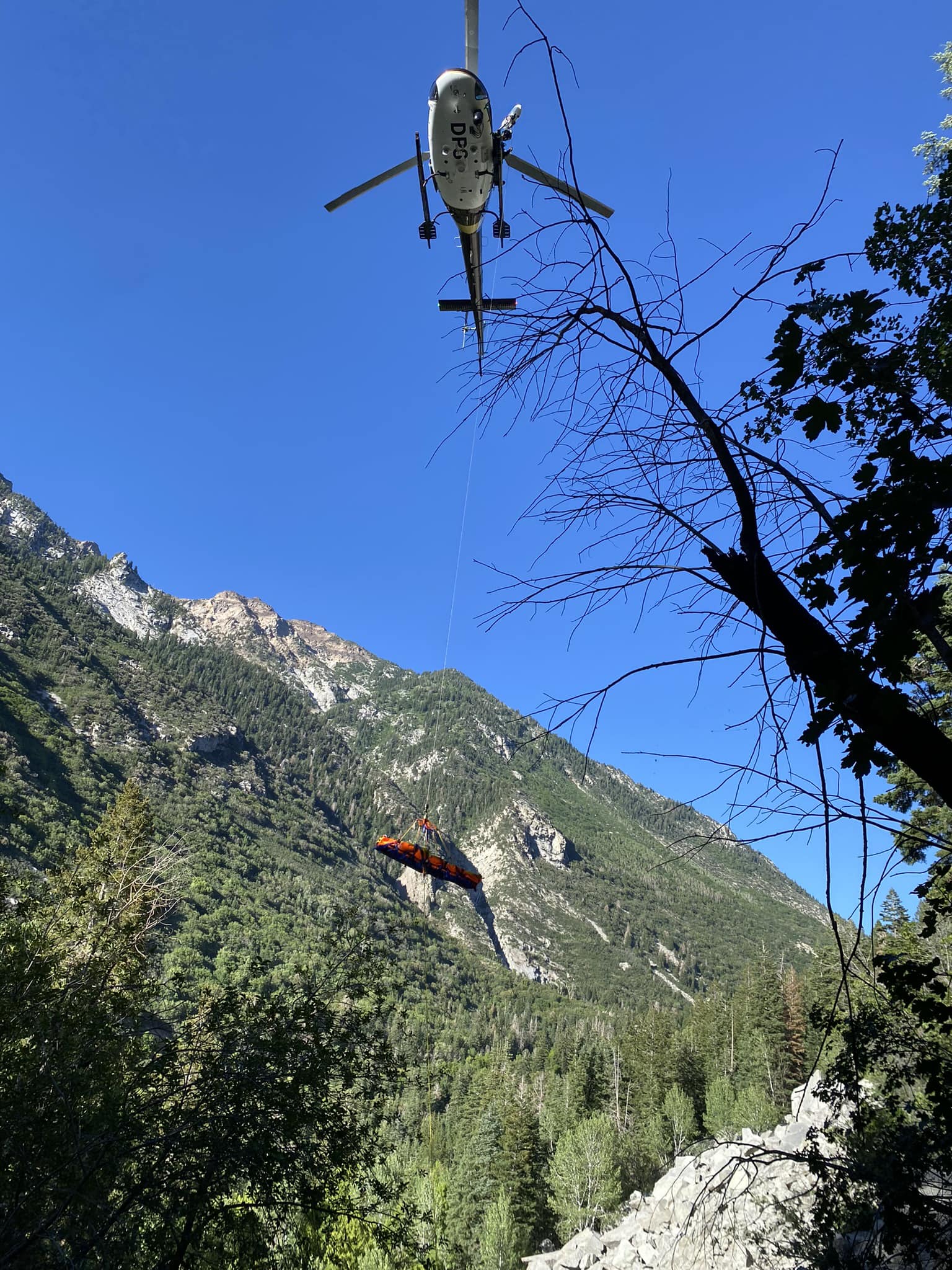 A helicopter lifts a hiker to safety July 13 at Little Cottonwood Canyon's Pentapitch climbing route.