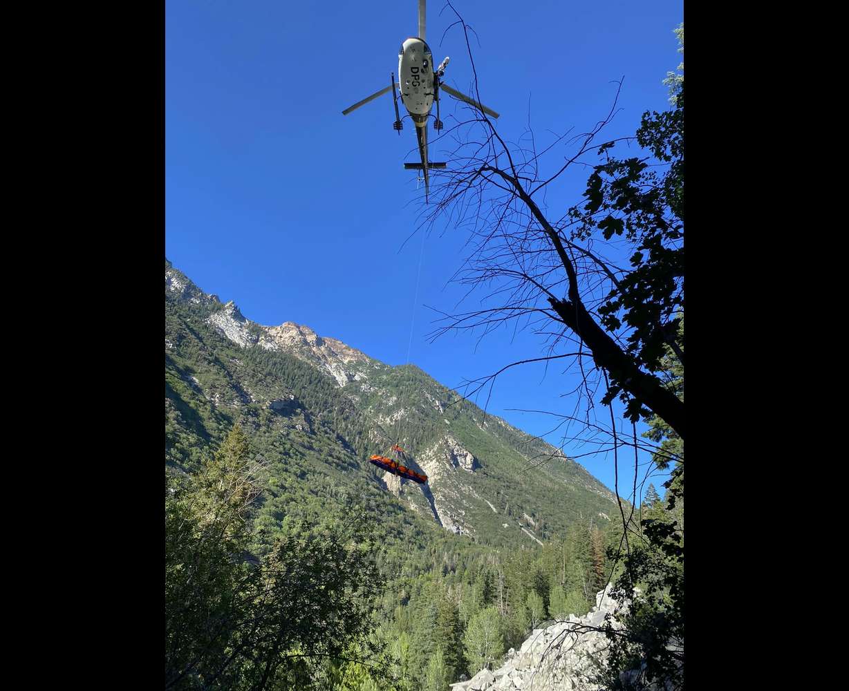 A helicopter lifts a hiker to safety July 13 at Little Cottonwood Canyon's Pentapitch climbing route.