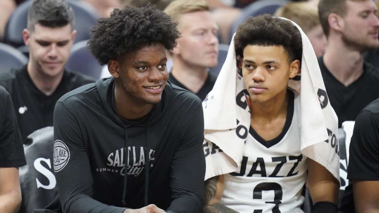 Utah Jazz first-round draft picks Taylor Hendricks, left, and Keyonte George sit on the bench during the second half of the team's NBA summer league basketball game against the Philadelphia 76ers on Wednesday, July 5, 2023, in Salt Lake City.