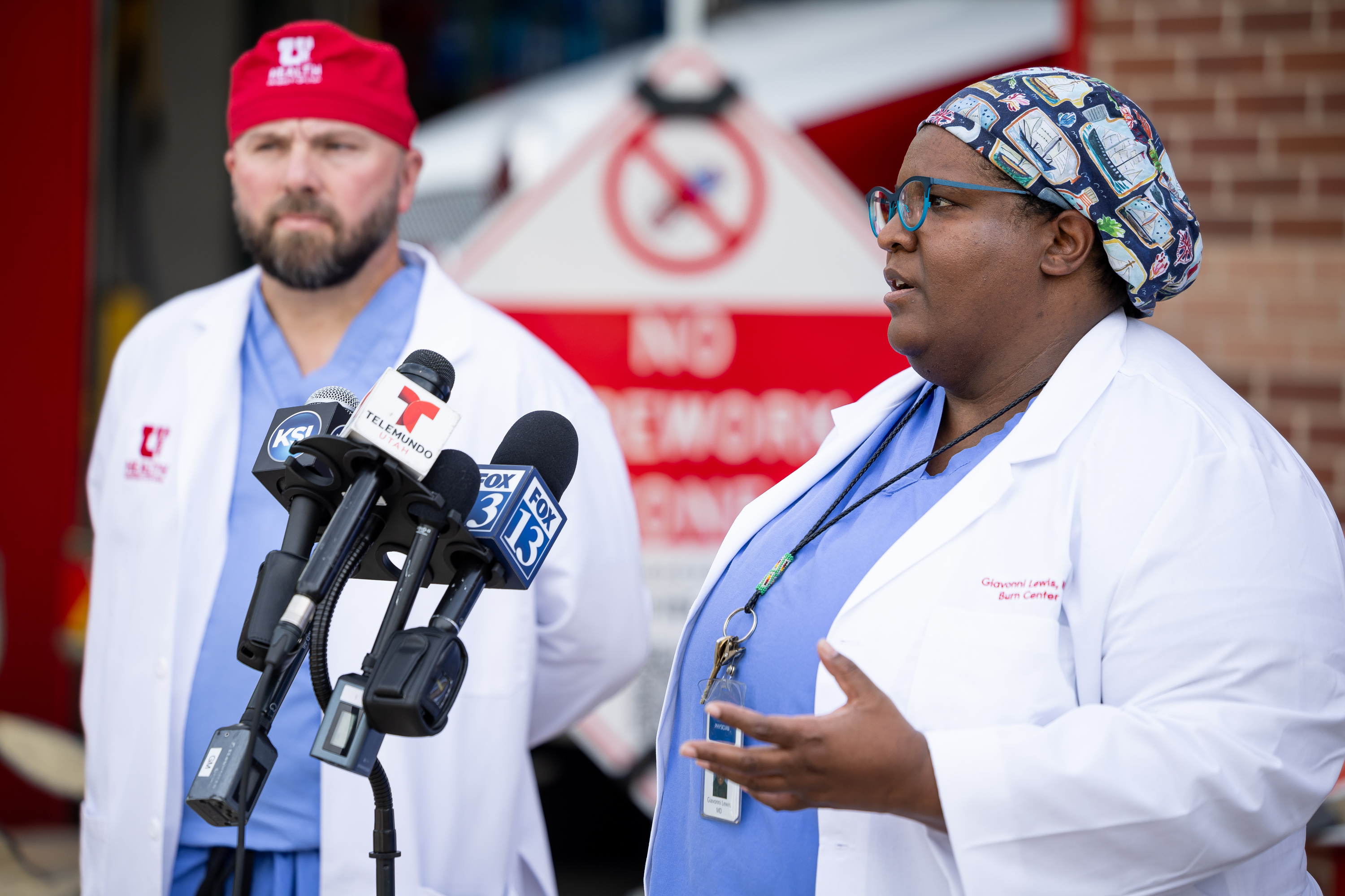 Dr. Giavonni Lewis, medical director of the University of Utah Burn Center, right, and Dr. Christopher LaChapelle, a surgeon at the Burn Center, left, speak at a press conference about heat and fire safety at Fire Station 10 in Salt Lake City on Monday.