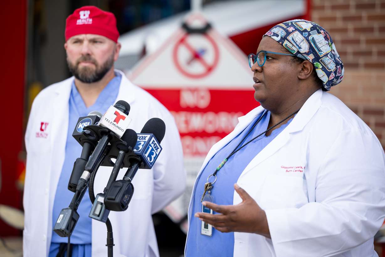 Dr. Giavonni Lewis, medical director of the University of Utah Burn Center, right, and Dr. Christopher LaChapelle, a surgeon at the Burn Center, left, speak at a press conference about heat and fire safety at Fire Station 10 in Salt Lake City on Monday.