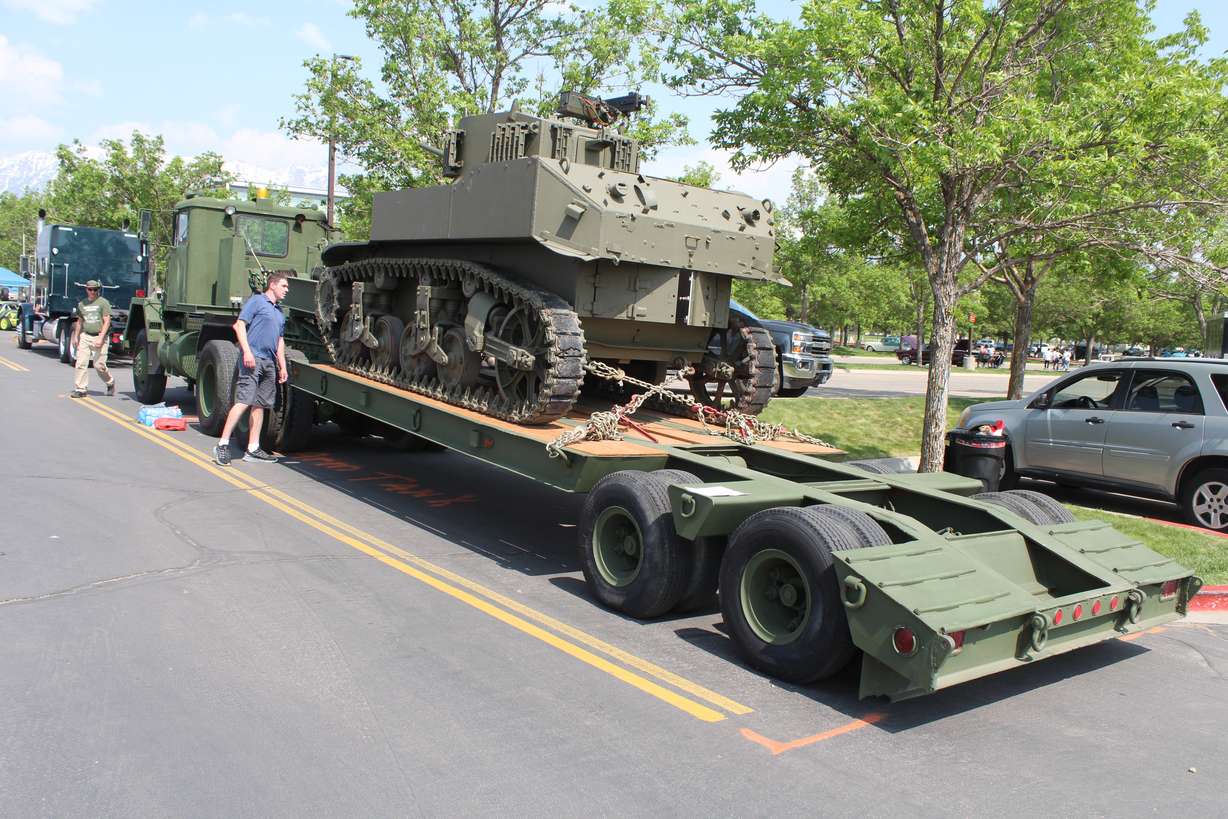 Stout watches an admirer of his Stuart tank at the Utah Valley University Auto Expo on May 20.