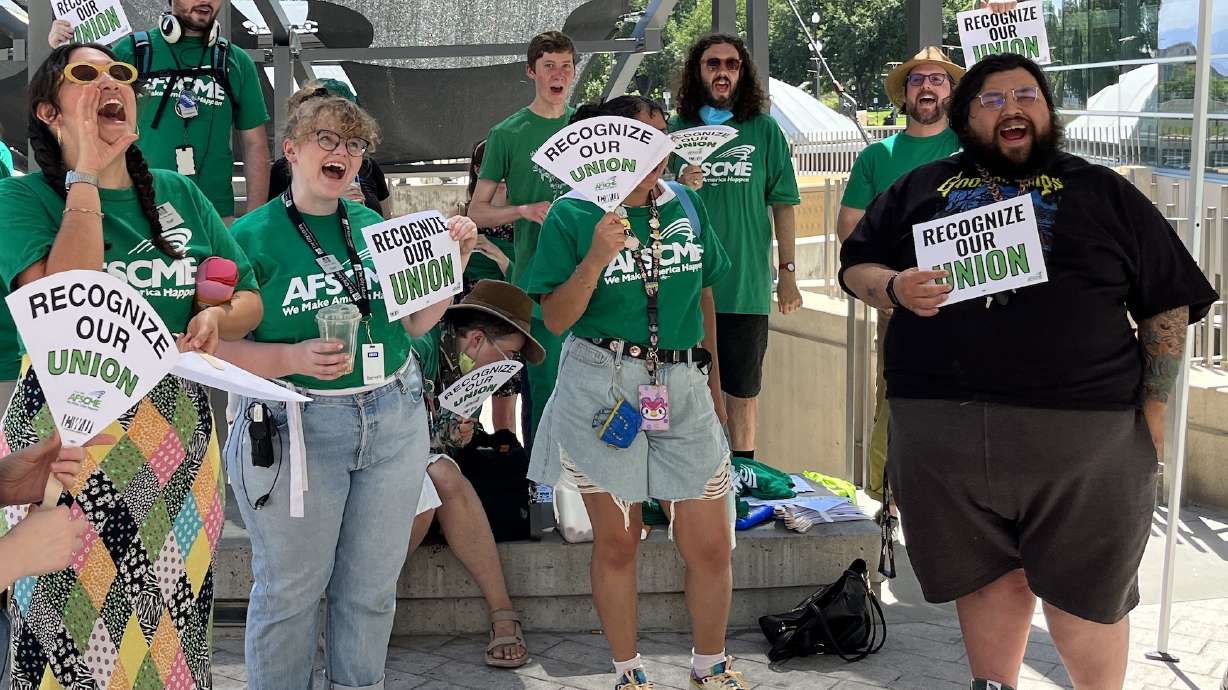 Librarians and library employees rally outside of the Salt Lake City Library before a board of directors meeting Monday. The group is asking the board to recognize its effort to unionize.