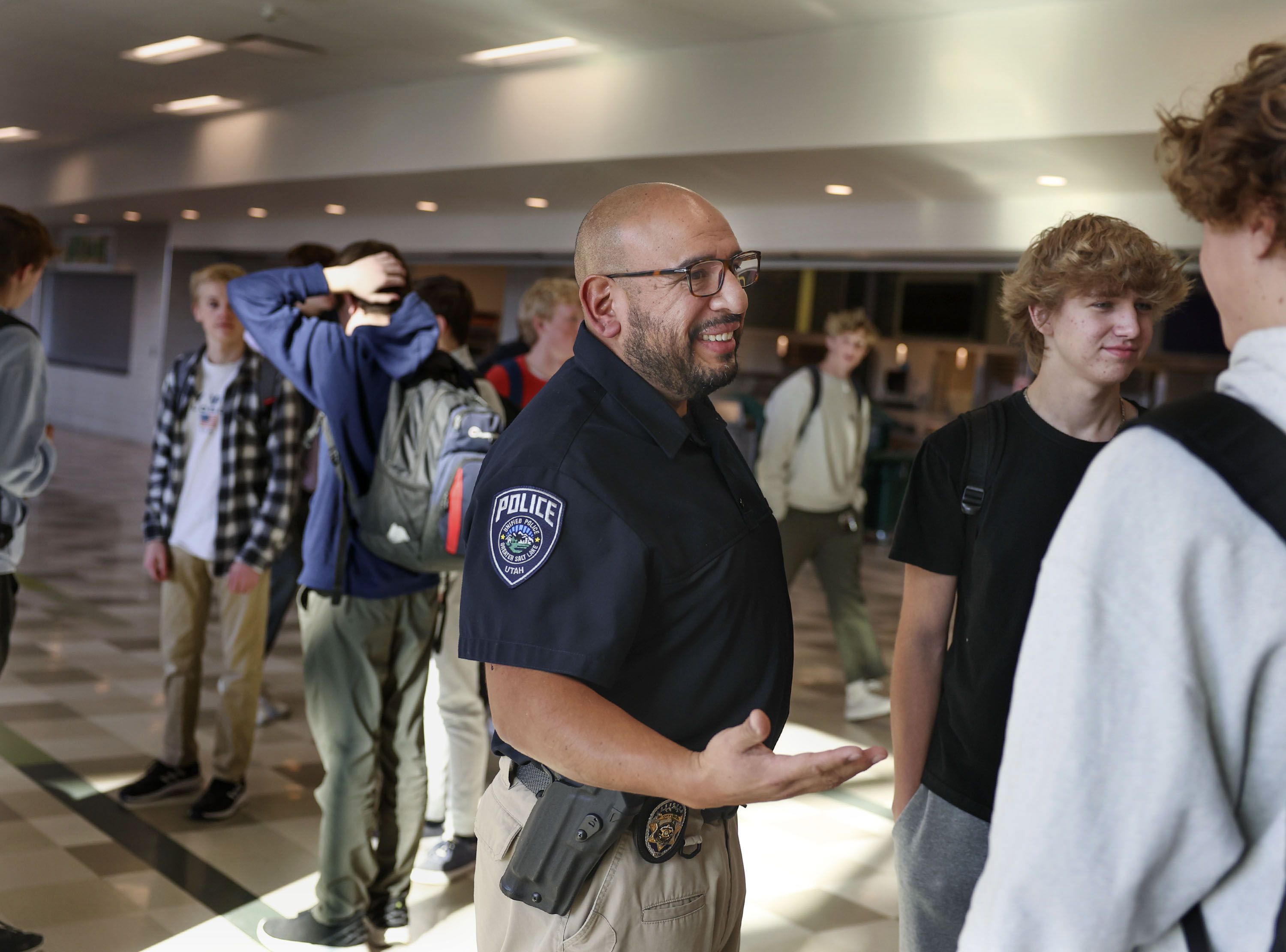 Unified police detective Jaime Cardenas speaks with students at Olympus High School Thursday, Feb. 2. Cardenas has been a school resource officer at the Holladay school for four years.