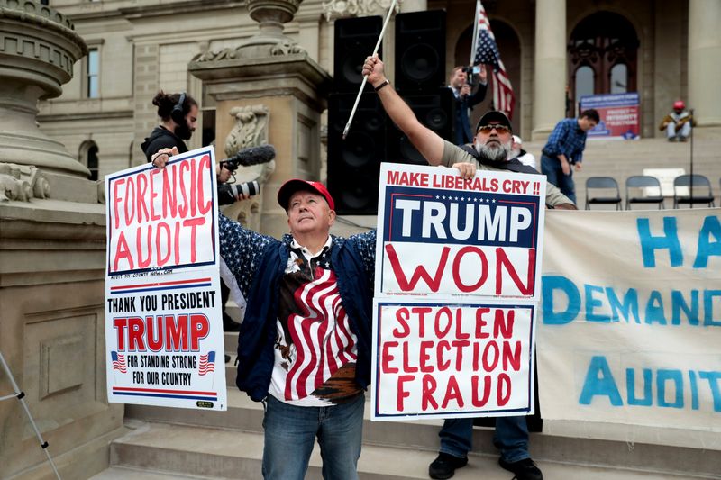 Protesters outside the Michigan State Capitol demand an audit of 2020 election votes, Oct. 12, 2021. Michigan's attorney general announced felony charges against 16 Republicans for participating in an alleged "false elector" scheme.