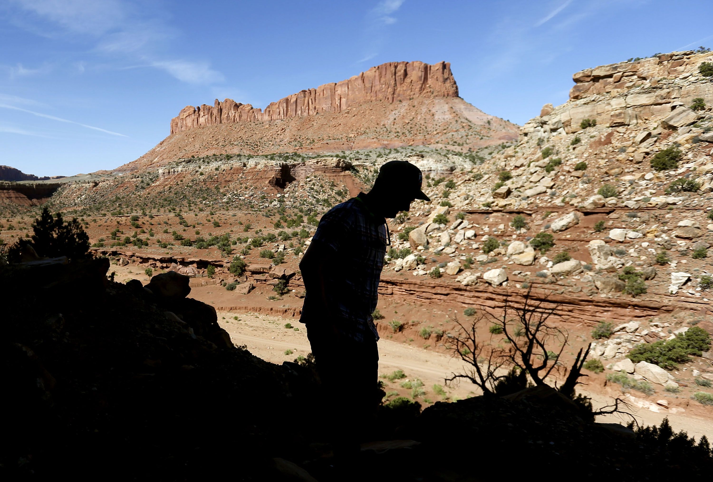 Nick Proctor walks in the Colt Mesa area of the former Grand Staircase-Escalante National Monument on May 14, 2021. The land pictured across from the dirt road is part of the national monument.