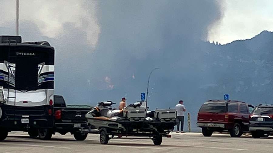 Campers backing up their gear to evacuate from the growing fire near Flaming Gorge on Monday.