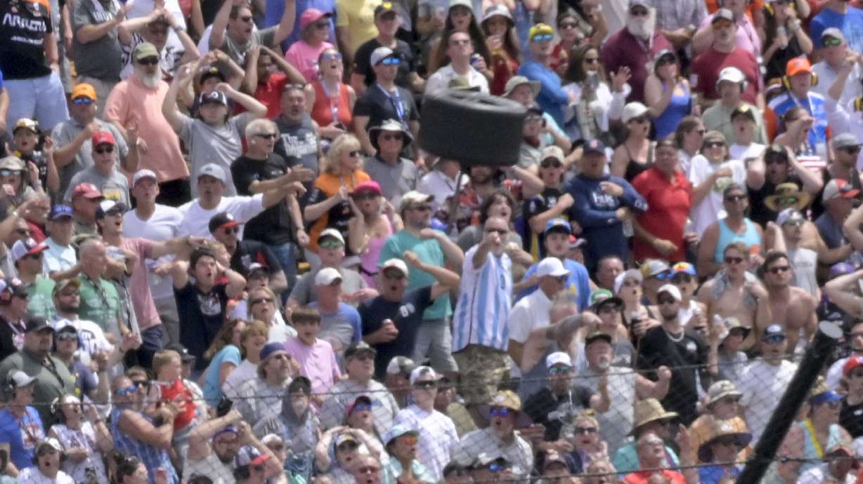FILE - A wheel flies near a section of grandstand in the second turn after a collision between Kyle Kirkwood and Felix Rosenqvist during the 107th running of the Indianapolis 500, Sunday, May 28, 2023, at Indianapolis Motor Speedway in Indianapolis. IndyCar will implement a new, stronger piece of hardware designed to keep rear wheels attached to the car during a wreck after a tire flew off Kyle Kirkwood's car and narrowly missed a packed grandstand during the Indianapolis 500. The series said Wednesday, July 19, that chassis manufacturer Dallara had designed a retaining nut that is more than 60% stronger than the previous design.