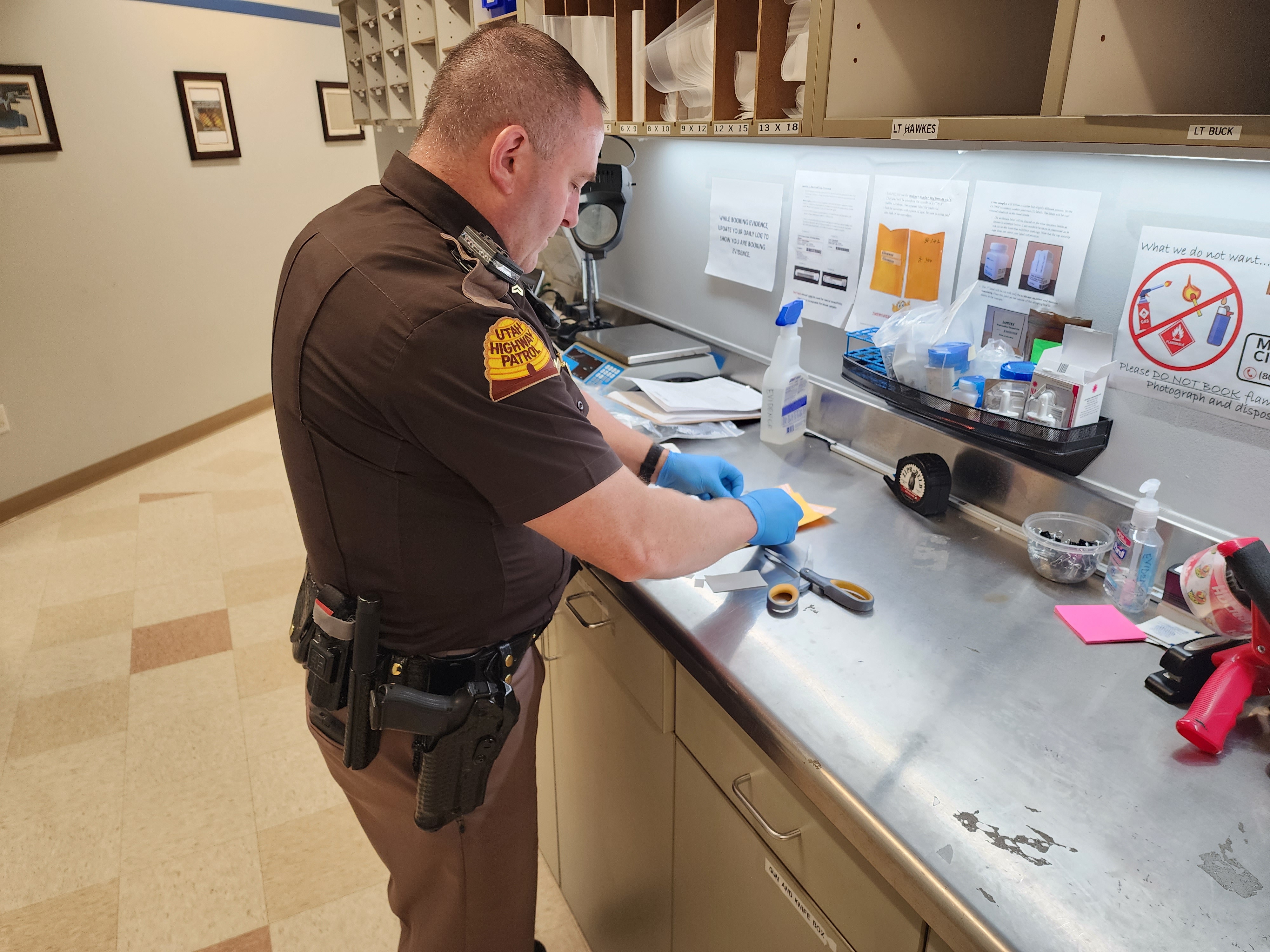 Utah Highway Patrol Cpl. Brock Ernstsen books evidence for a suspected DUI arrest on an overnight shift in Salt Lake City earlier this month.