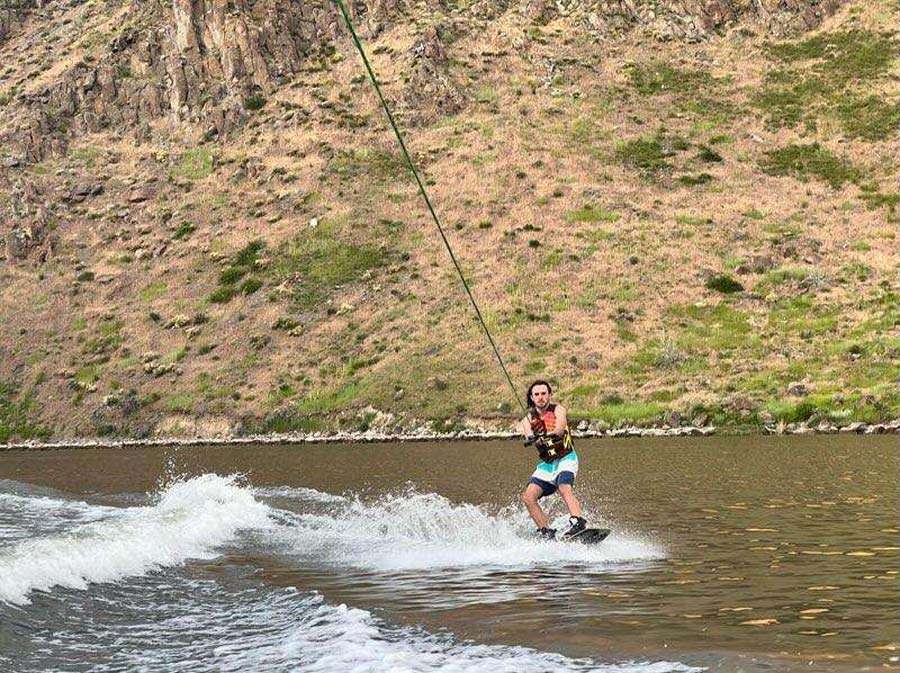 Joseph Noyes wakeboards on July 9. His sister, Tasia Noyes, is recovering at home after she was bitten by a rattlesnake while swimming.
