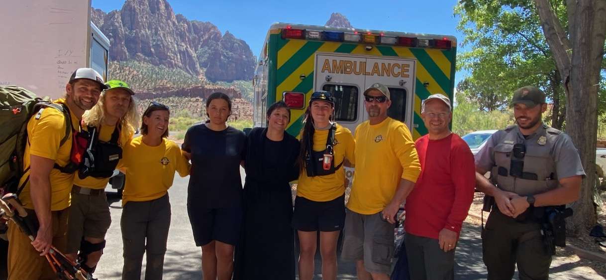 Aloha Joy and Aurelia Lunceford (center) stand with Zion National Park Search and Rescue, grateful Aloha made it out safe.