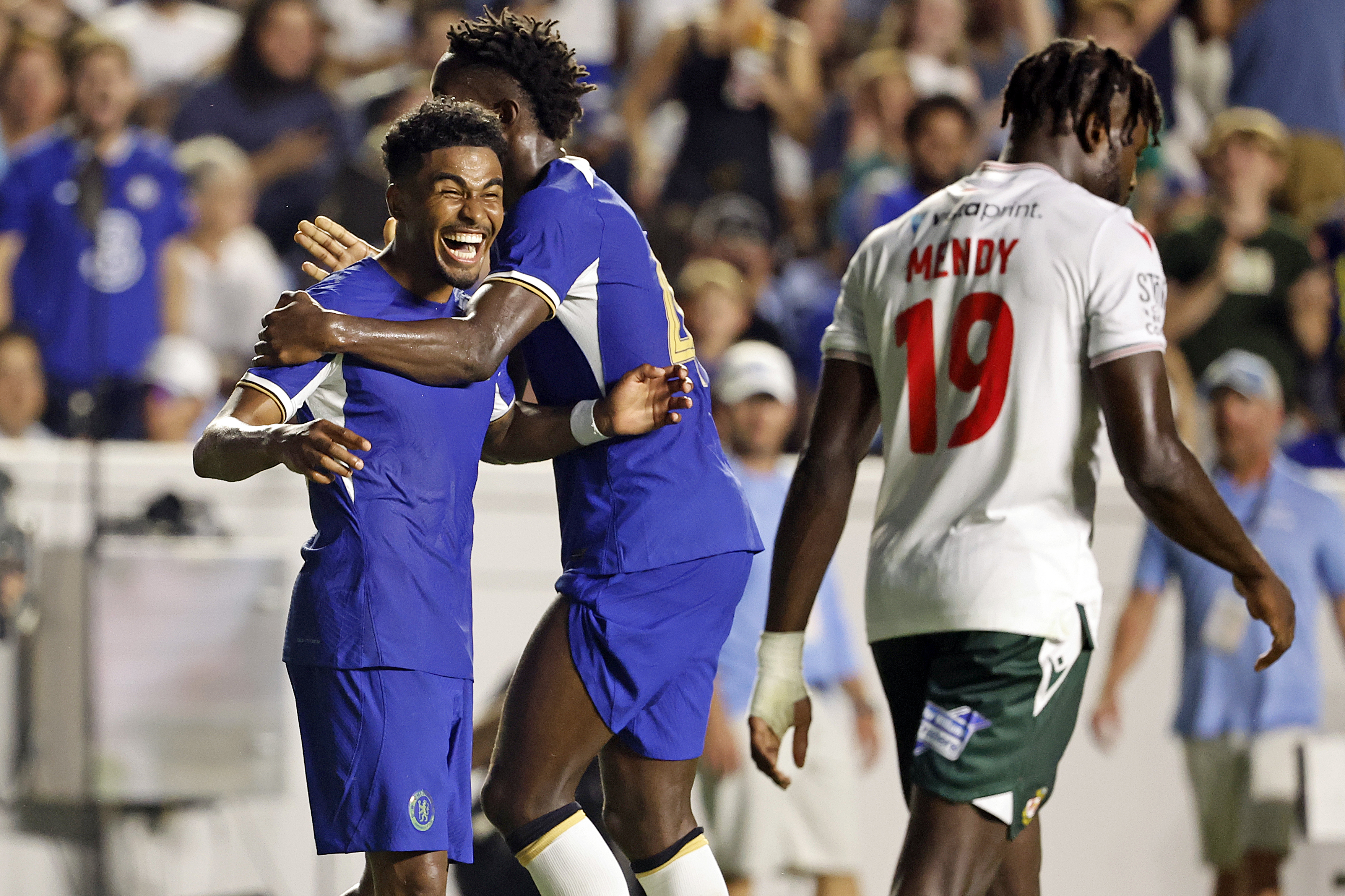 Chelsea's Ian Maatson, left, celebrates a goal with Nicolas Jackson, center, while Wrexham's Jacob Mendy (19) walks past during the first half of a club friendly soccer match Wednesday, July 19, 2023, in Chapel Hill, N.C. 