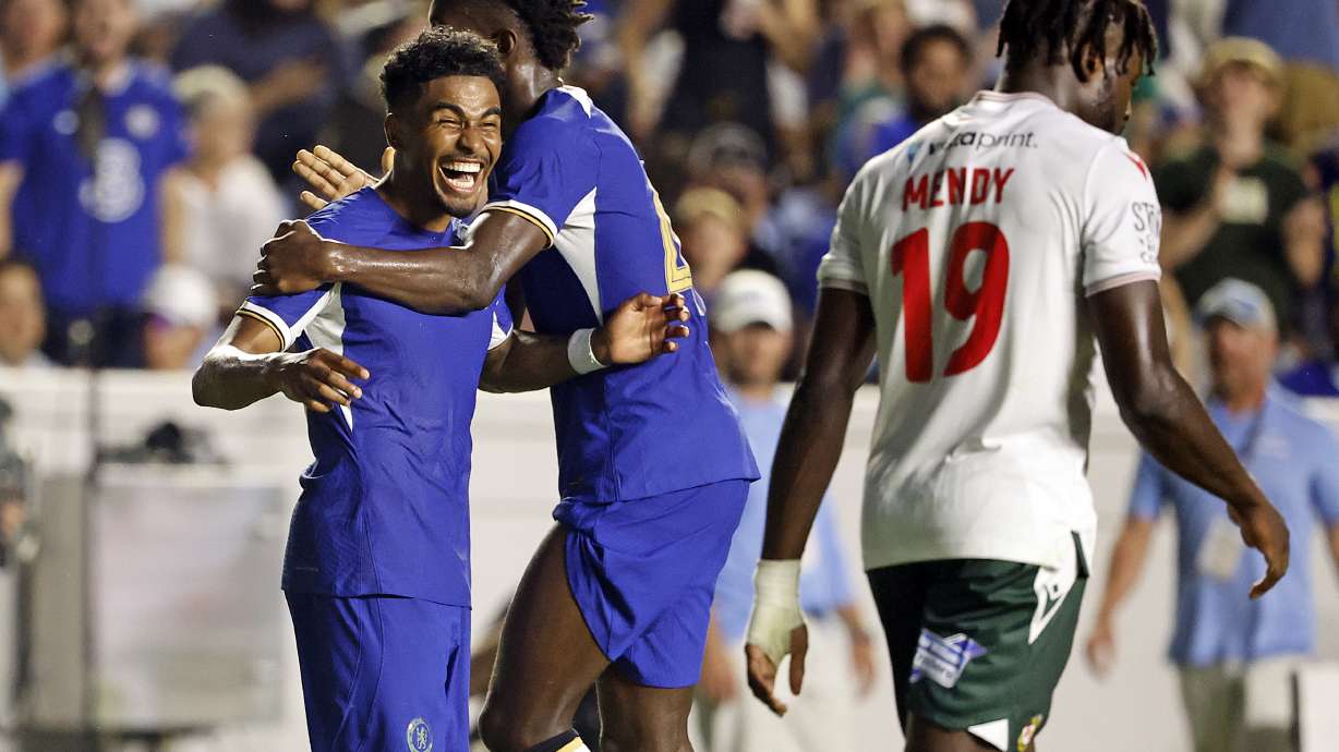 Chelsea's Ian Maatson, left, celebrates a goal with Nicolas Jackson, center, while Wrexham's Jacob Mendy (19) walks past during the first half of a club friendly soccer match Wednesday, July 19, 2023, in Chapel Hill, N.C.