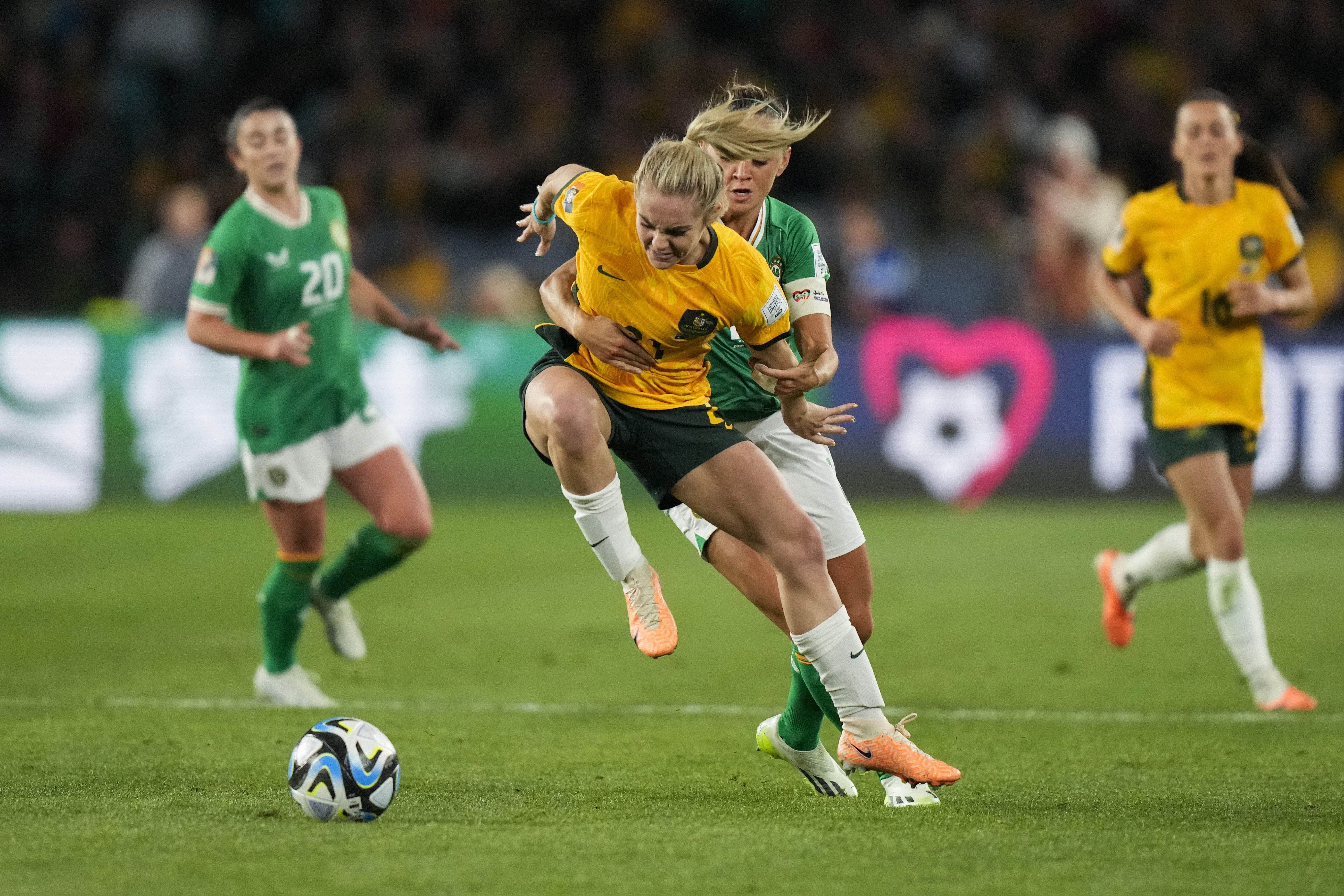 Australia's Ellie Carpenter, left, battles for the ball with Ireland's Katie McCabe during the Women's World Cup soccer game between Australia and Ireland at Stadium Australia in Sydney, Australia, Thursday, July 20, 2023. 
