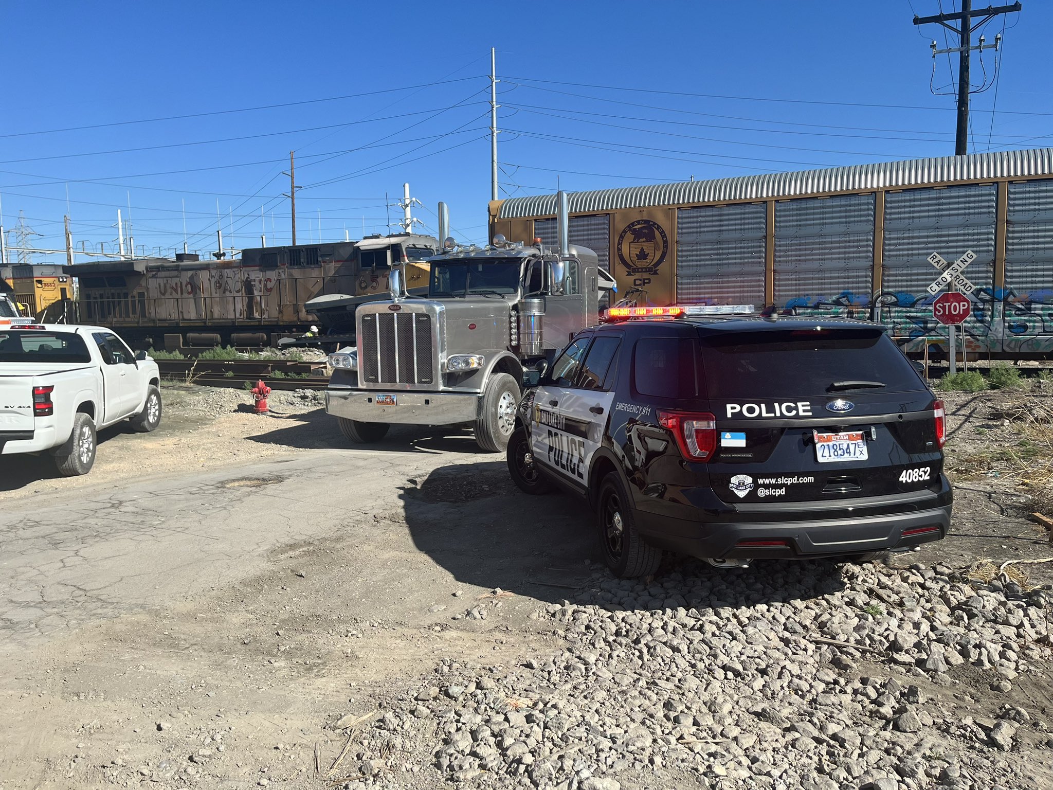 A police vehicle is pictured at the scene of a crash between a train and a semitruck in Salt Lake City on Thursday.