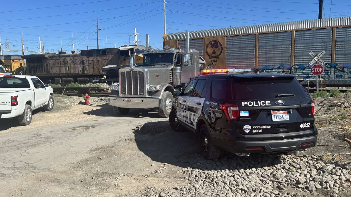 A police vehicle is pictured at the scene of a crash between a train and a semitruck in Salt Lake City on Thursday.