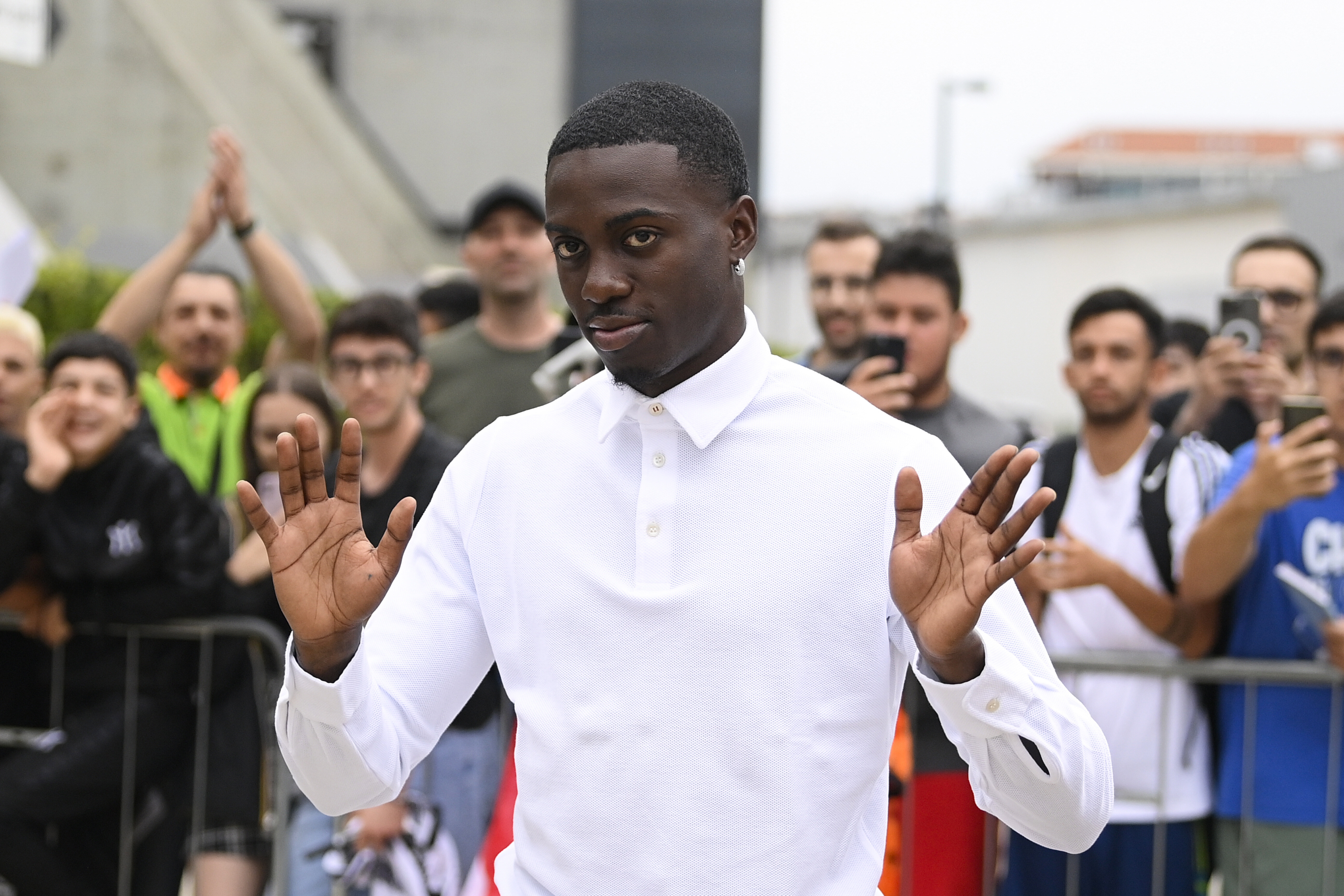 US soccer player Timothy Weah, front, waves as he arrives for fitness tests at the Italian soccer club Juventus F.C. in Turin, Italy, Thursday, June 29, 2023. 