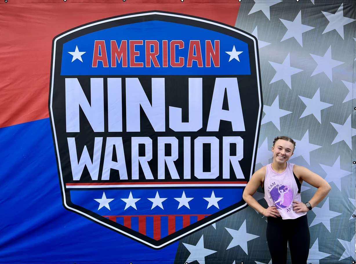 Anna McArthur, 16, poses in front of the "American Ninja Warrior" poster at Universal Studios and Athlete Headquarters in Los Angeles in March.