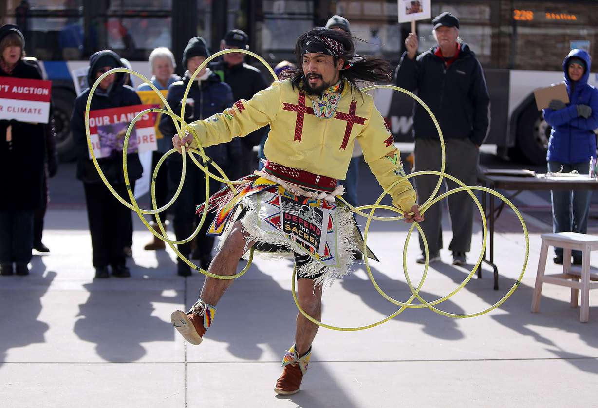 Carl Moore performs a hoop dance during a mock climate auction and rally outside the Bureau of Land Management office in Salt Lake City on Dec. 7, 2016.