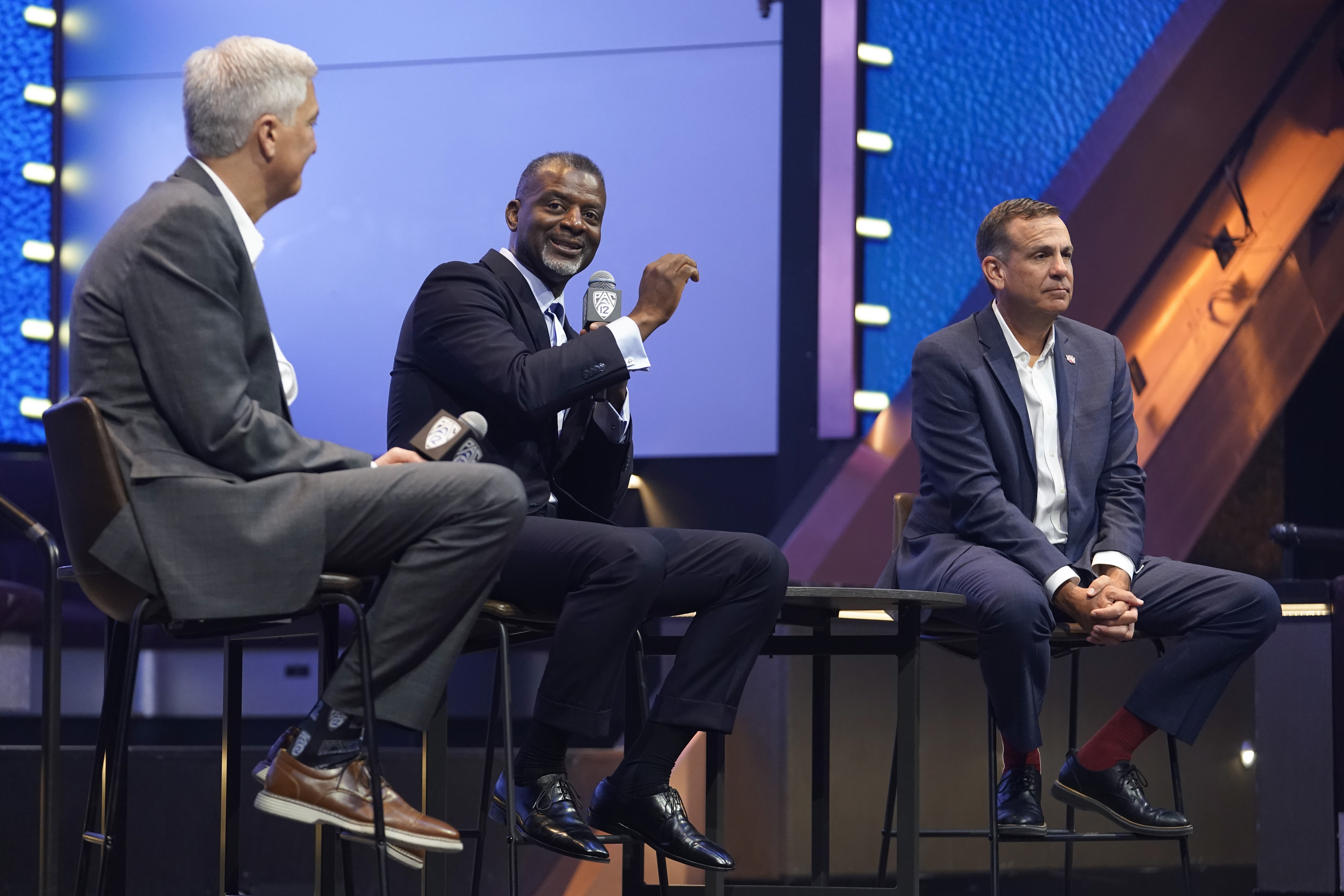 Pac-12 associate commissioner Merton Hanks answers questions with Pac-12 commissioner George Kliavkoff, left, and Utah athletic director Mark Harlan at the NCAA college football Pac-12 media day Friday, July 21, 2023, in Las Vegas.