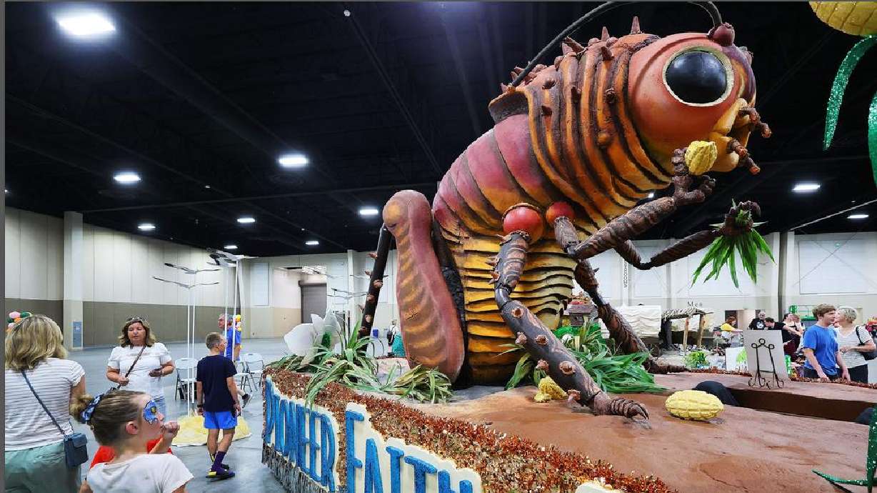 Attendees walk past the Sandy Crescent Stake float during a float preview party held at the Mountain America Expo Center in Sandy on Friday.