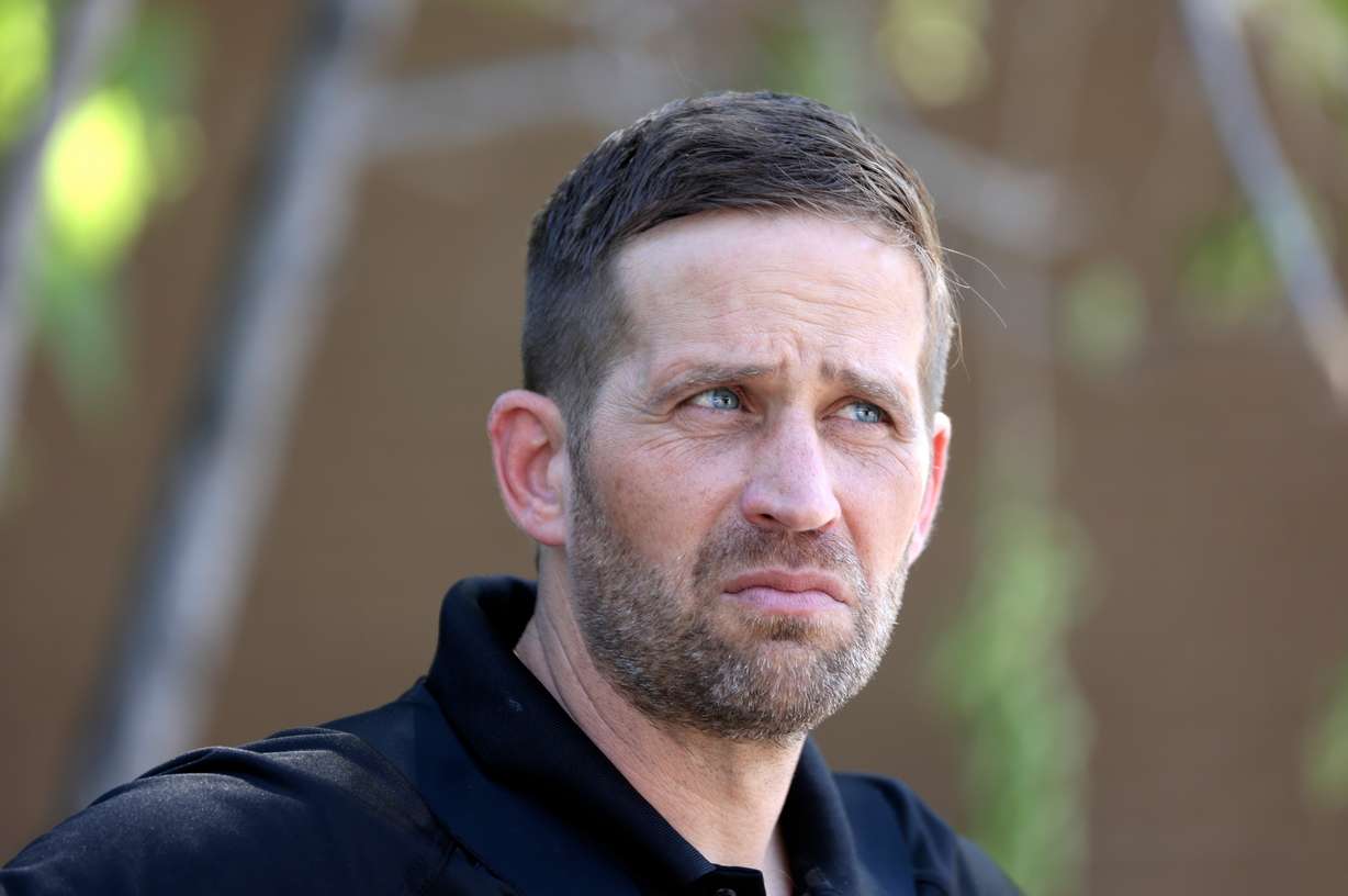 Brian Redd, Utah Department of Corrections executive director, works in the field as Adult Parole and Probation agents take a probation fugitive into custody in South Salt Lake on Thursday.