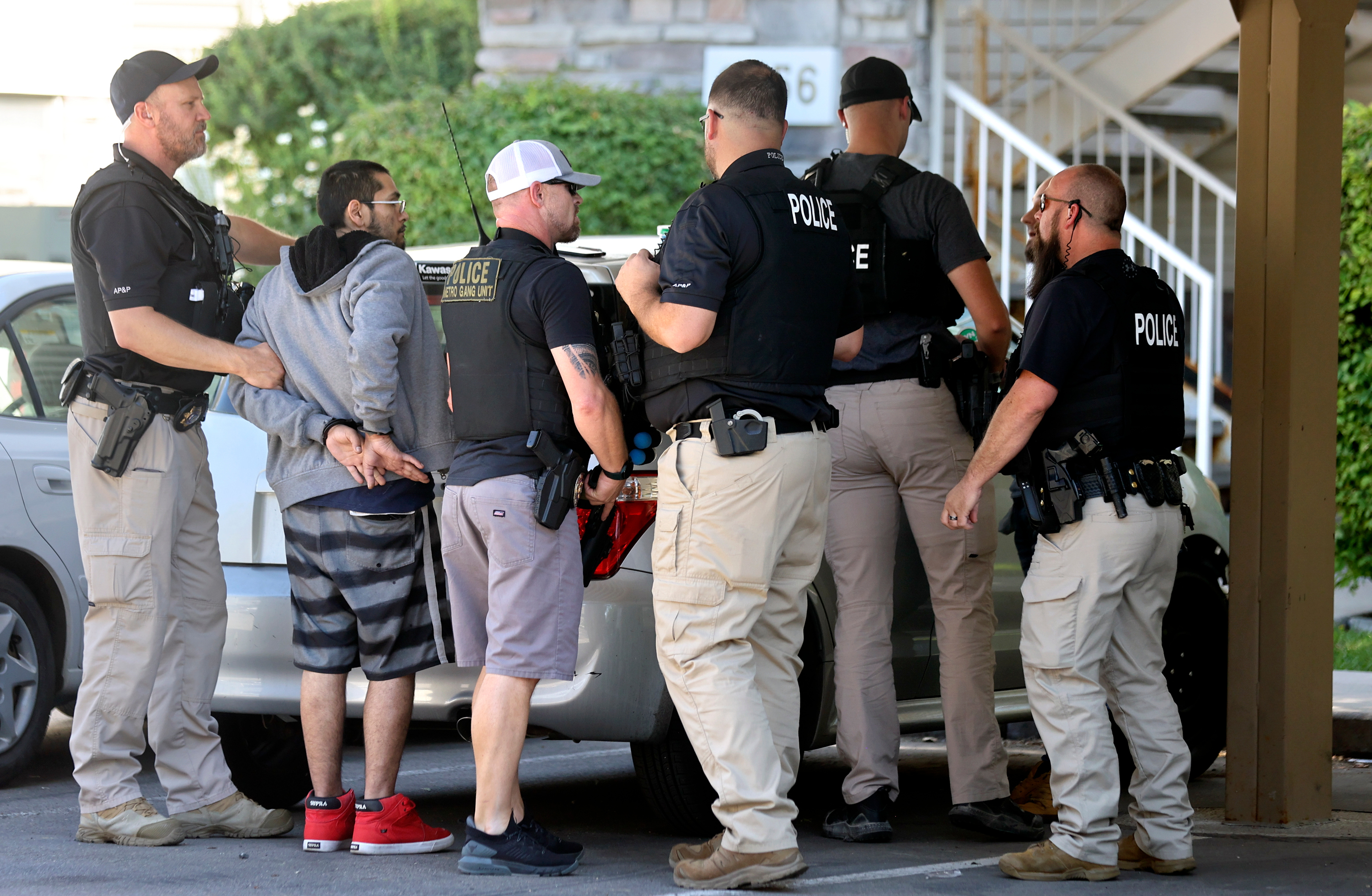 Adult Probation and Parole agents take an unidentified fugitive into custody in Salt Lake County on Thursday. Agents said the man was on probation for a second degree felony threat and third degree felony aggravated assault with domestic violence enhancement.