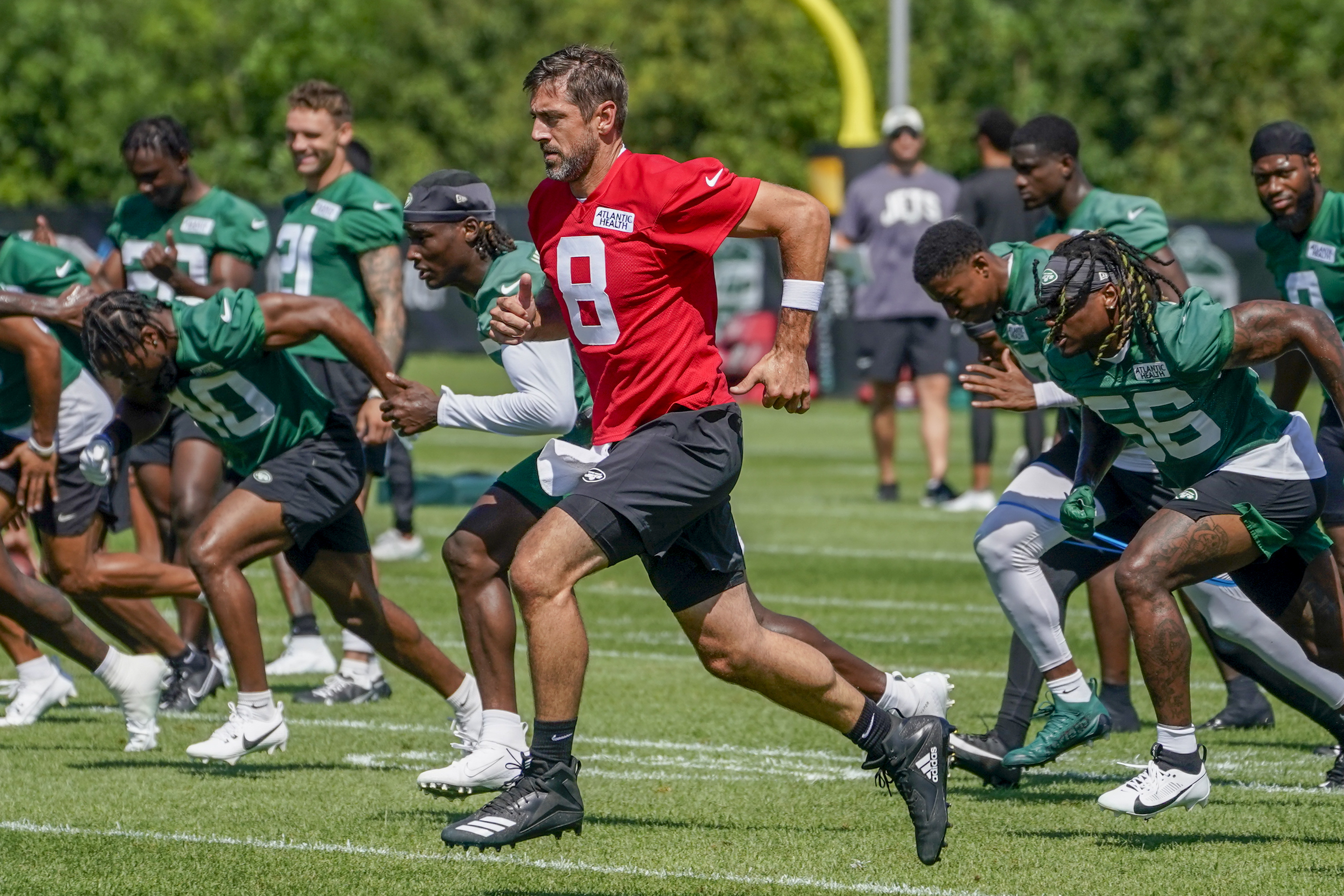 New York Jets quarterback Aaron Rodgers (8) warms up during practice at the NFL football team's training facility, Friday, July 21, 2023, in Florham Park, N.J. 