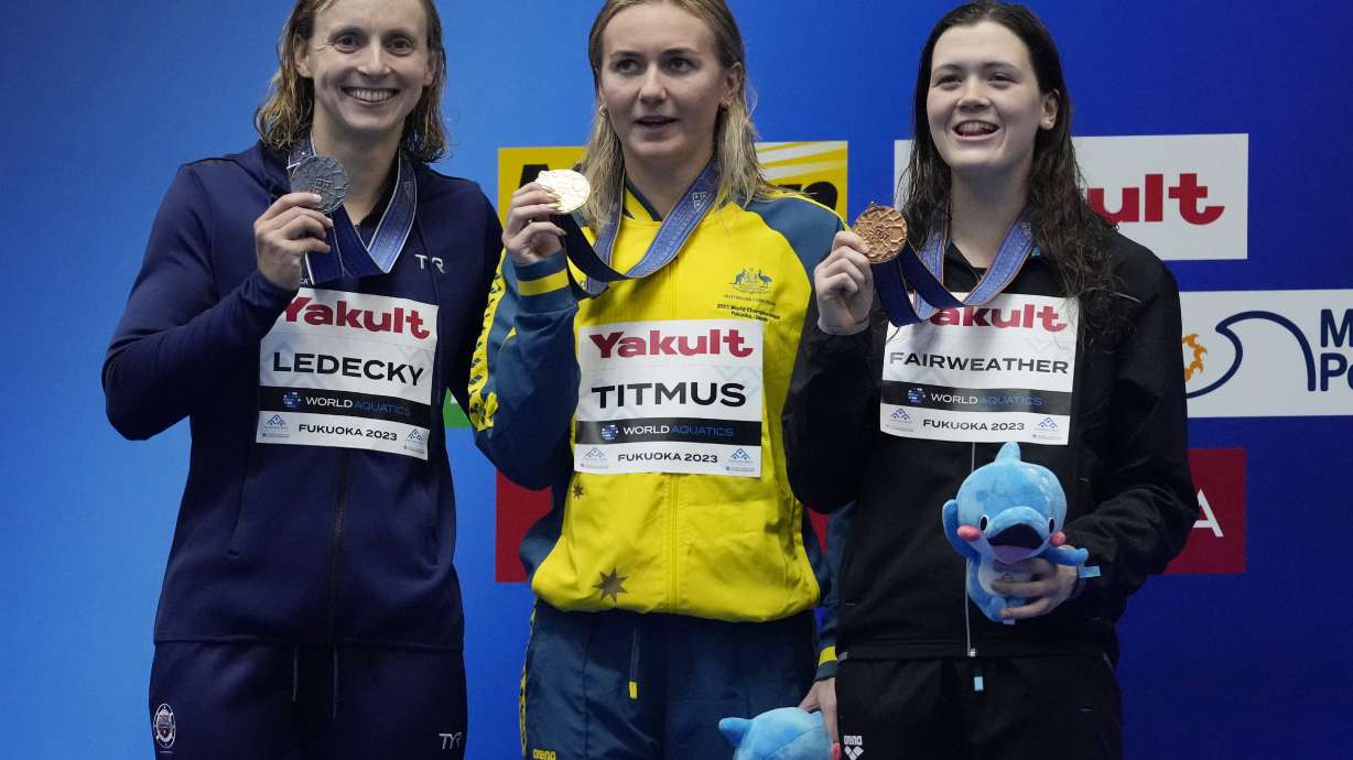 Gold medallist Ariarne Titmus of Australia, center, is flanked by silver medallist Katie Ledecky of the United States, and bronze medallist Erika Fairweather of New Zealand as they pose with their medals after winning Women 400m Freestyle finals at the World Swimming Championships in Fukuoka, Japan, Sunday, July 23, 2023.