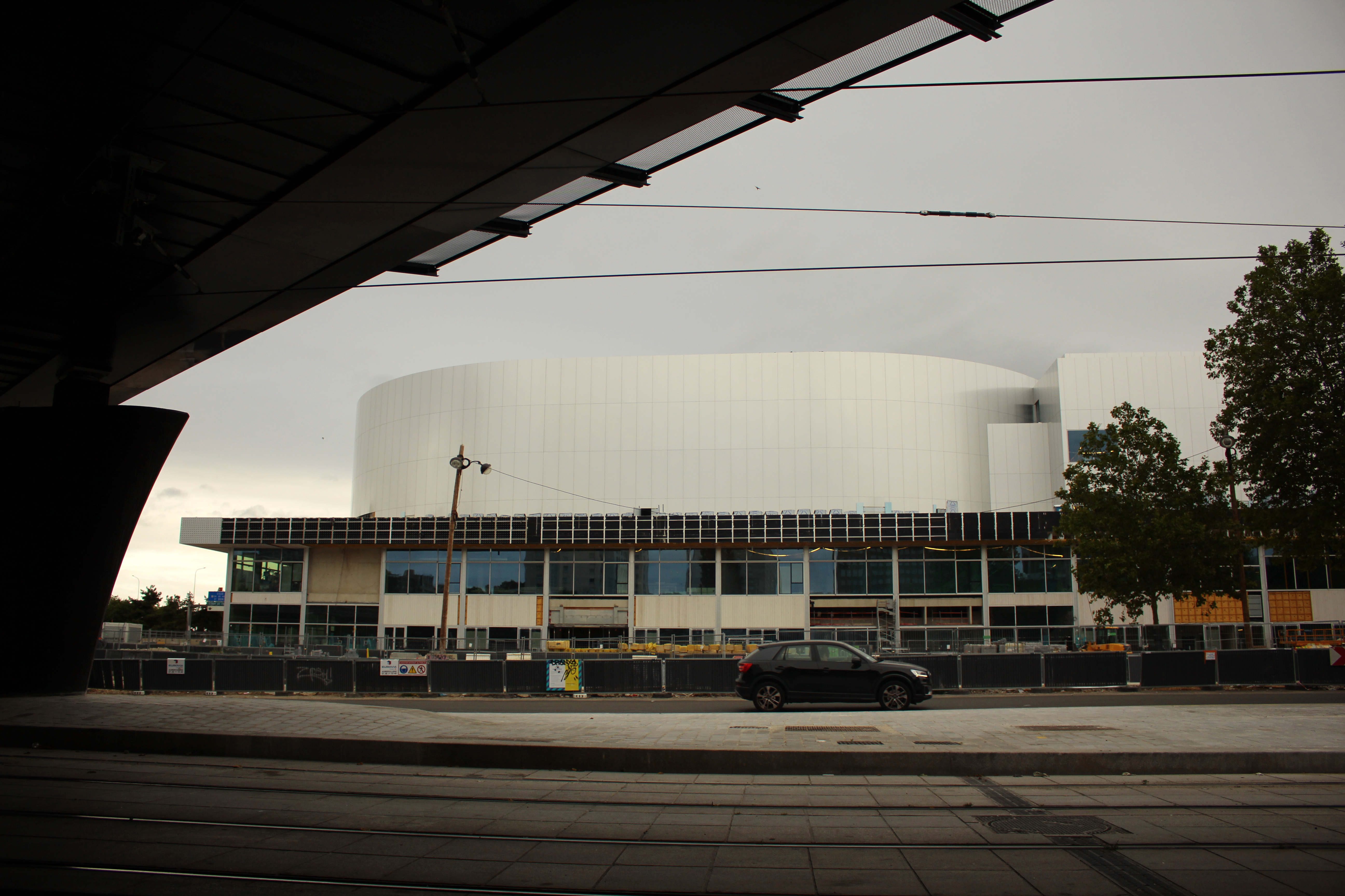 A car drives past the future Olympic venue "Porte de la Chapelle Arena" in Paris, Sunday, July 23, 2023. Paris authorities are trying to clear out crack users from a long-blighted neighborhood near a new venue built for the Paris 2024 Olympics, with mixed effects. 