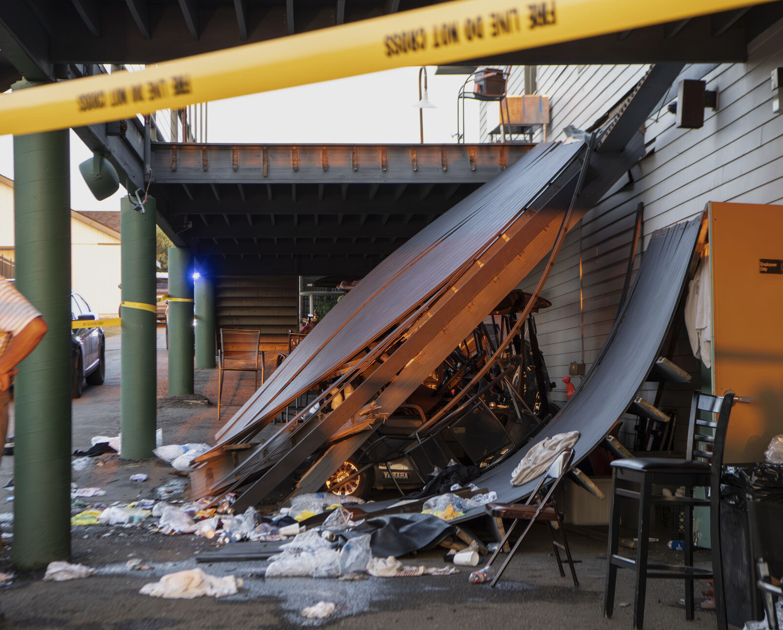 Police tape is wrapped around the scene of a deck collapse at Briarwood Country Club in Billings, Mont., Sunday. The deck collapsed, leaving more than 30 injured on Saturday evening.