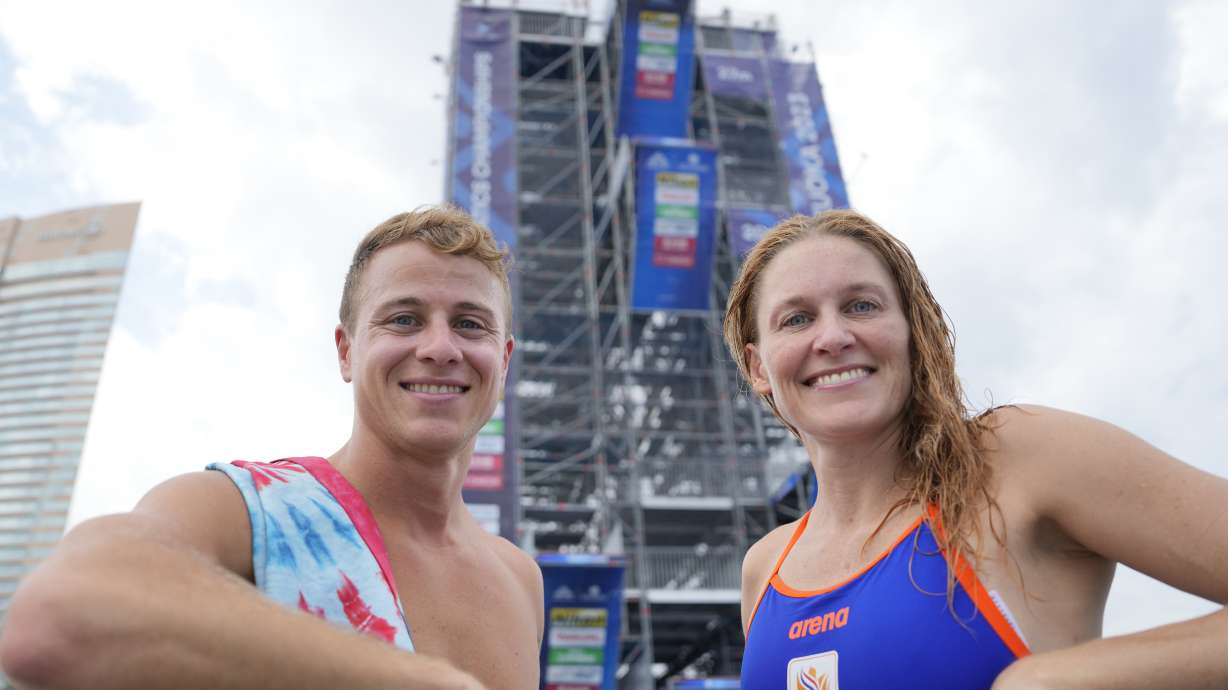 Matt Cooper, left, of the Unites States and his wife Ginni van Katwijk, right, of the Netherlands pose during a practice session of high diving at the World Swimming Championships at Seaside Momochi Beach Park in Fukuoka, Japan,Saturday, July 22, 2023.
