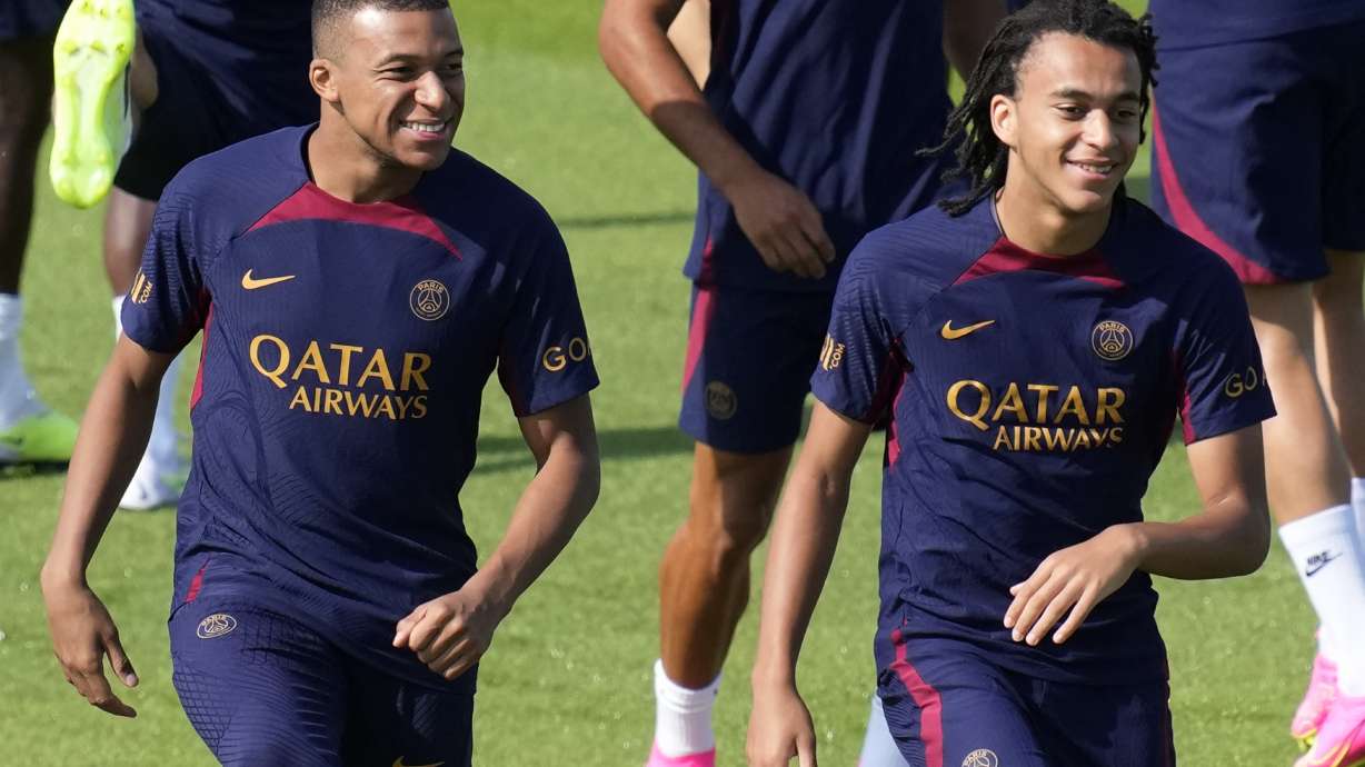 Kylian Mbappe, left, and his brother Ethan Mbappe attend a training session at the new Paris Saint-Germain training center Thursday, July 20, 2023 in Poissy, west of Paris.