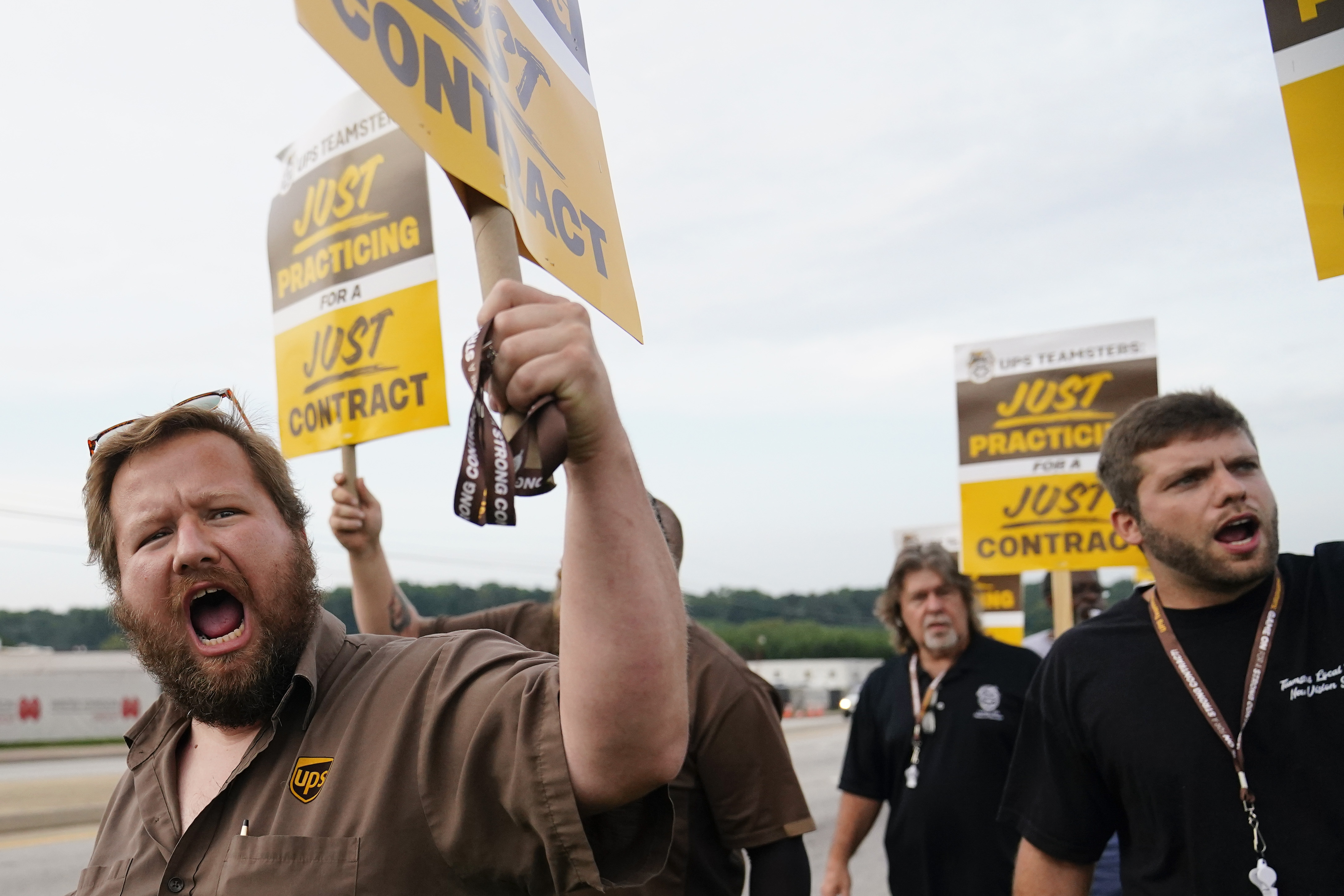 UPS teamsters and workers hold a rally on Friday in Atlanta, as a national strike deadline nears. UPS has reached a contract with its union, averting a potential strike that would have disrupted deliveries nationwide.