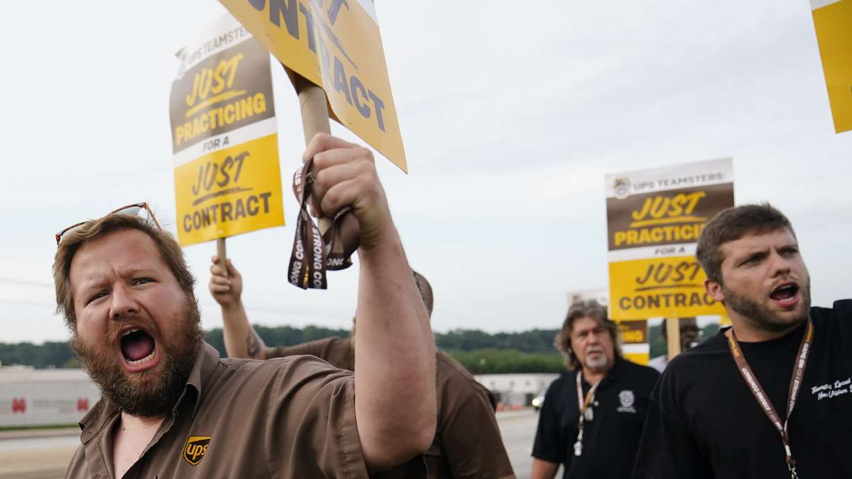 UPS teamsters and workers hold a rally on Friday in Atlanta, as a national strike deadline nears. UPS has reached a contract with its union, averting a potential strike that would have disrupted deliveries nationwide.