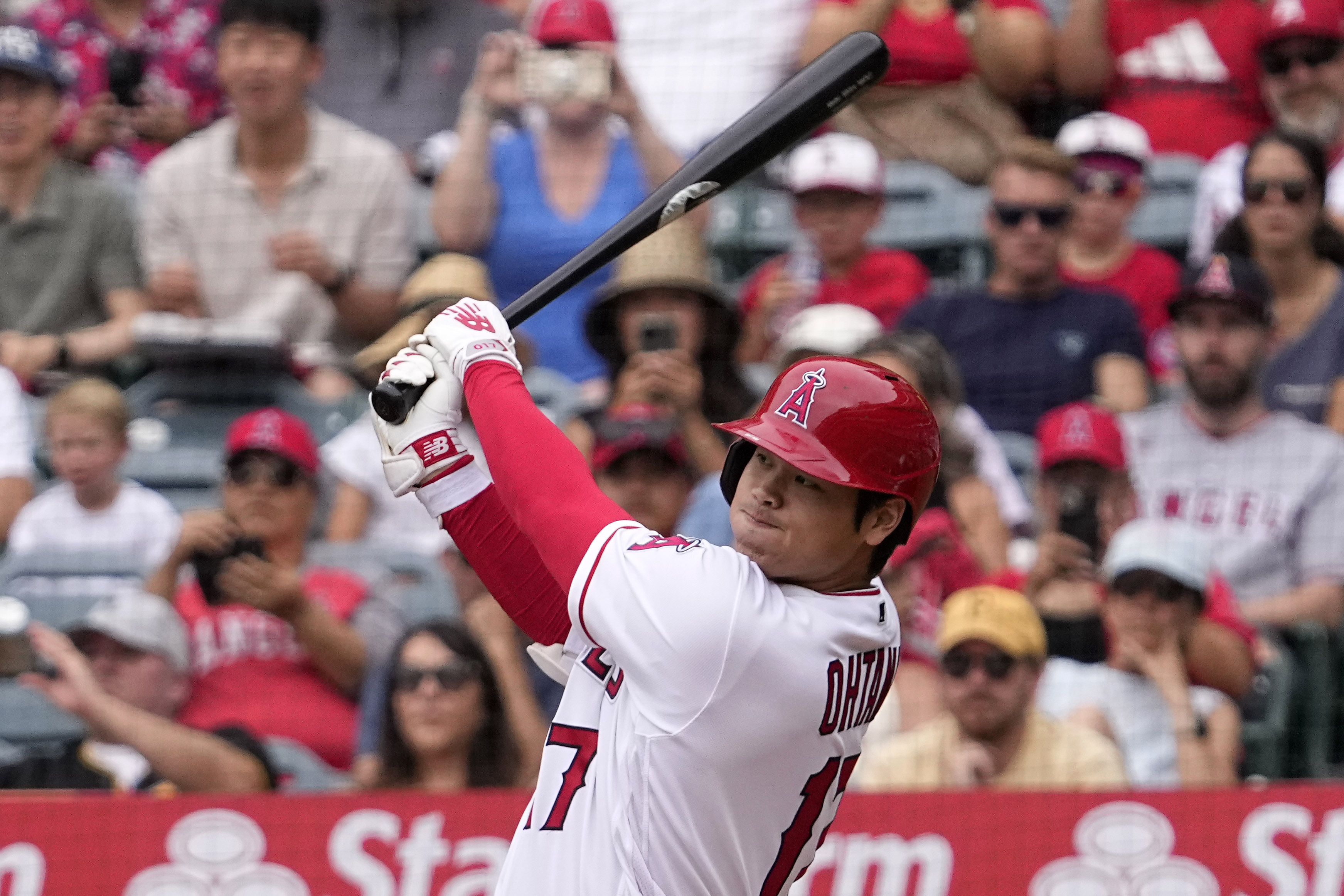 Los Angeles Angels' Shohei Ohtani follows through as he hits a solo home run during the first inning of a baseball game against the Pittsburgh Pirates, Sunday, July 23, 2023, in Anaheim, Calif.