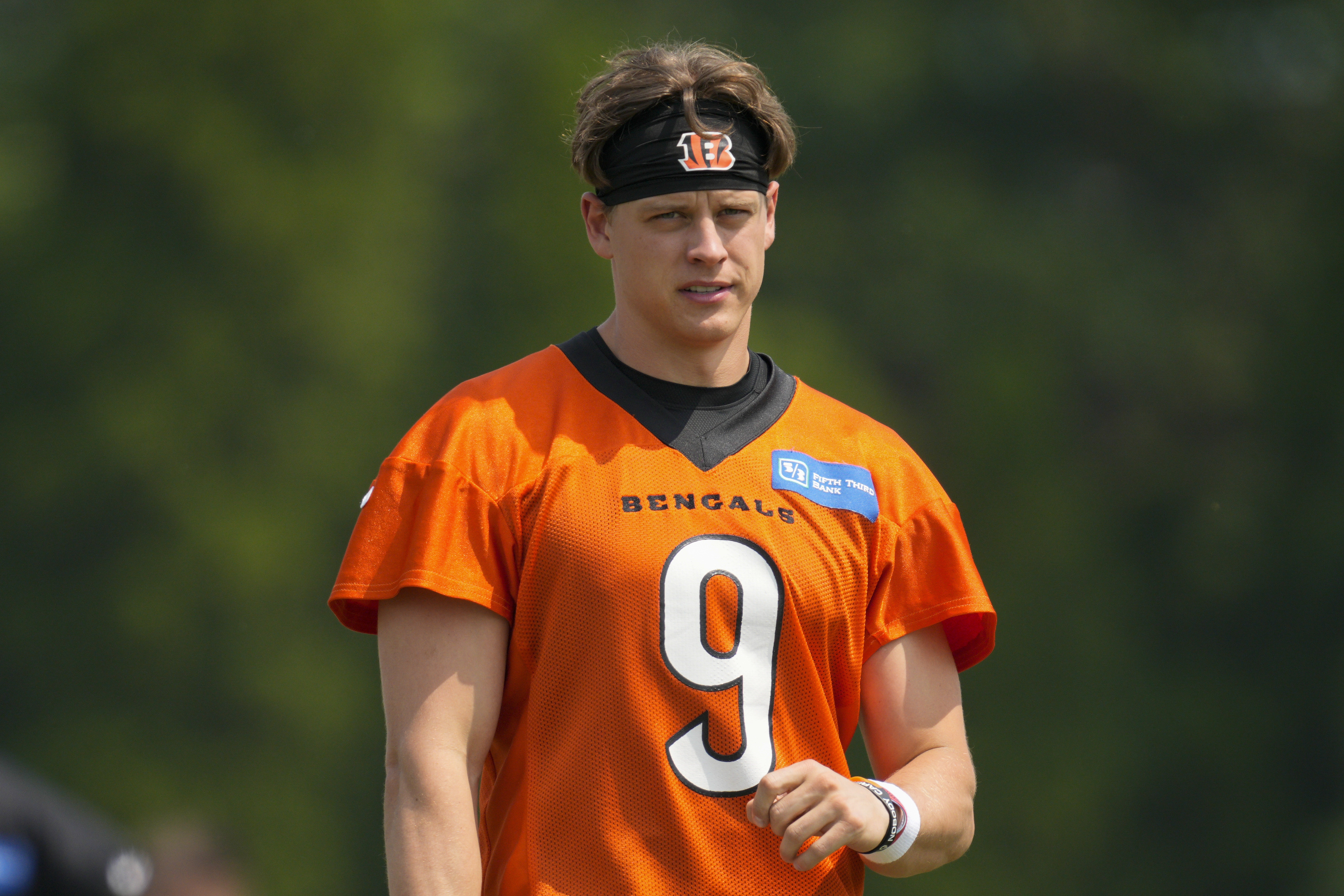 FILE - Cincinnati Bengals quarterback Joe Burrow (9) takes part in a drill during practice at the team's NFL football training facility, Tuesday, June 6, 2023, in Cincinnati. Burrow has reported to training camp amid negotiations for a long-term contract with the team that's expected to make him one of the NFL's highest paid players.