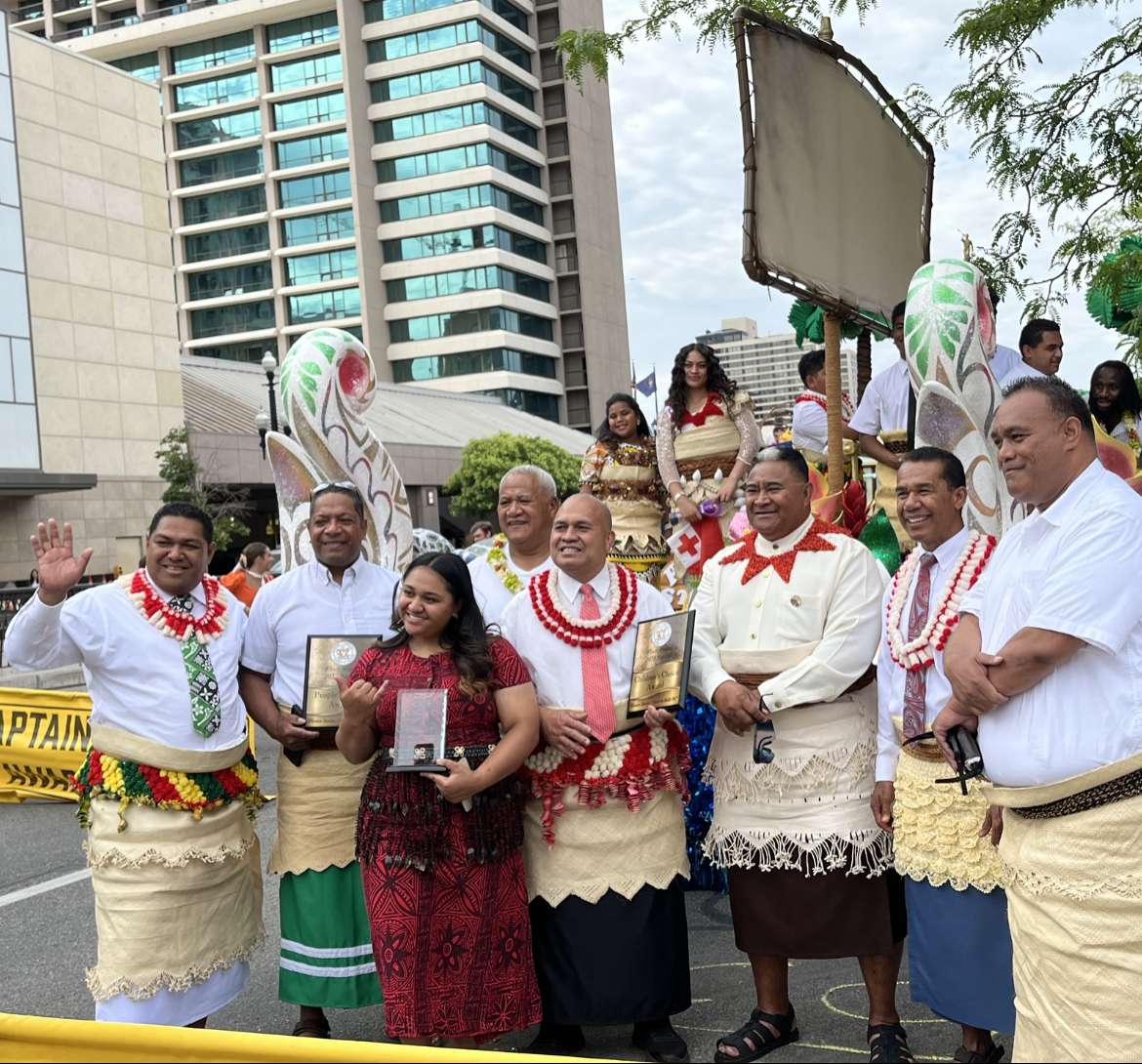 Members of the Salt Lake Utah Tongan West Stake stand with their float and award plaques during the Days of '47 Parade on Monday.