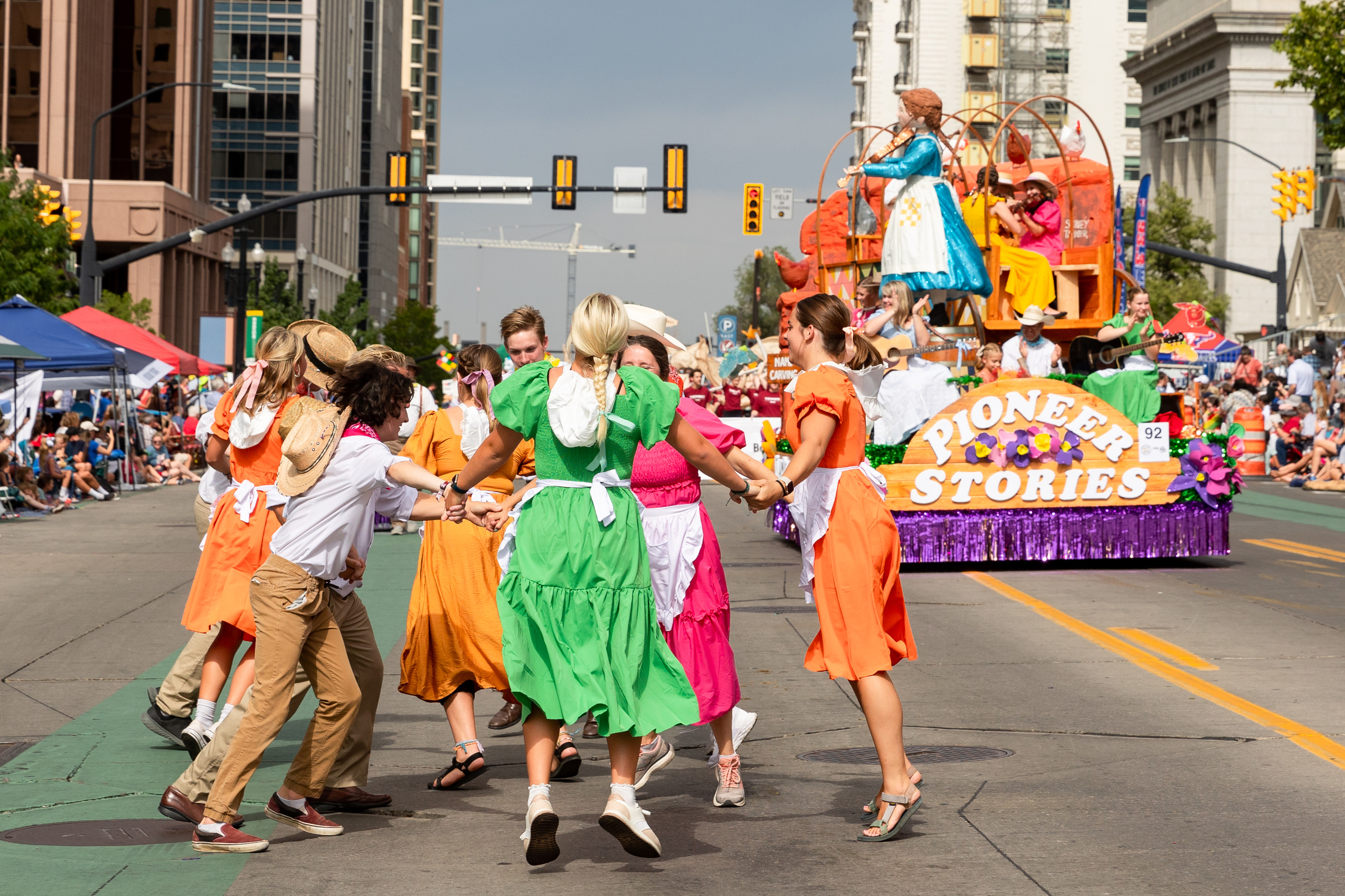 Parade participants with the float Pioneer Stories dance on the parade route during the annual Days of ’47 Parade in Salt Lake City on Monday.