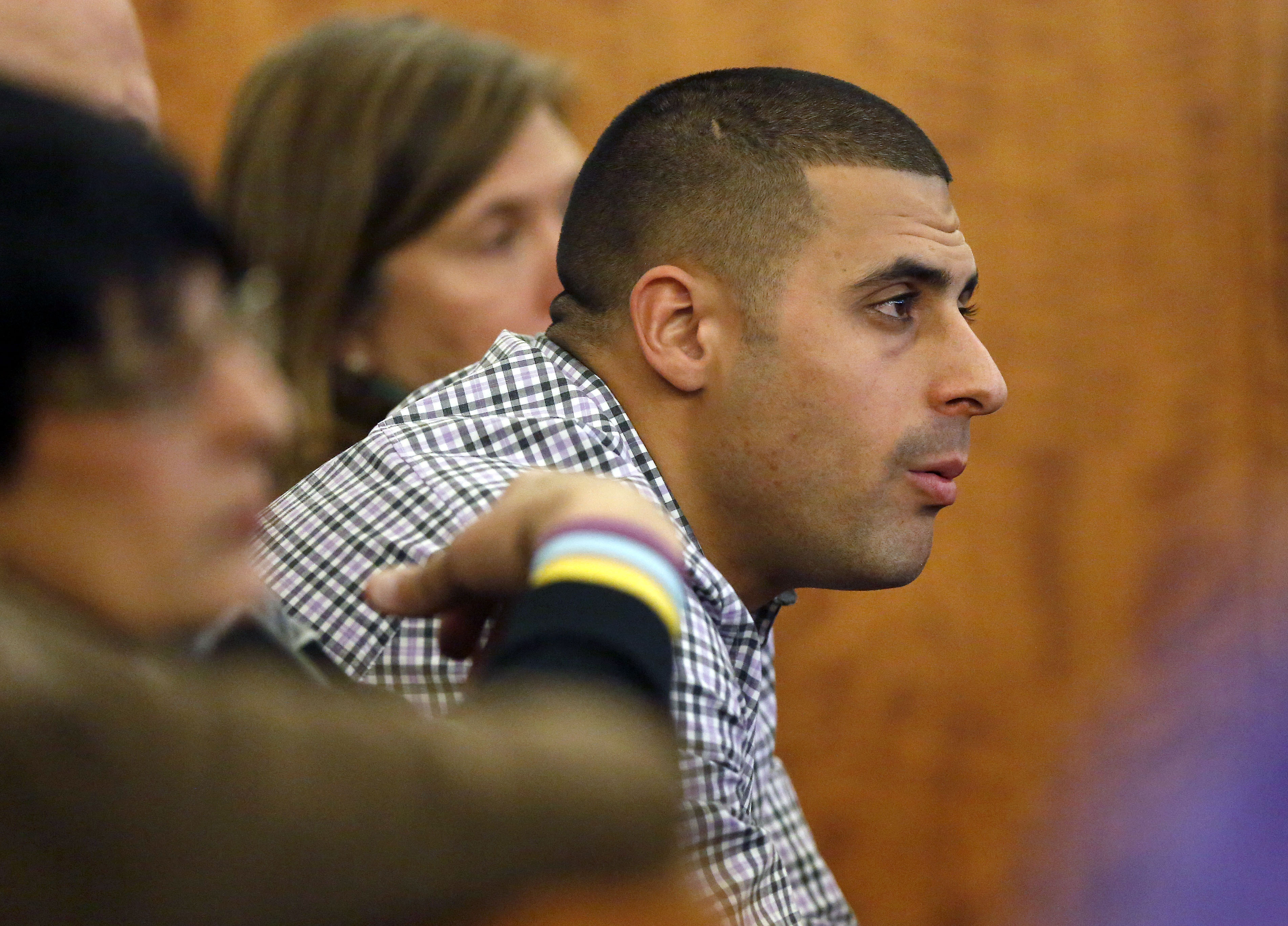 FILE - Dennis Hernandez, brother of former New England Patriots NFL football player Aaron Hernandez, watches during his brother's murder trial on Jan. 29, 2015, in Fall River, Mass. Former UConn football player Dennis Hernandez is behind bars after a witness told police she believed he was planning a school shooting. The 37-year-old, who went by DJ while playing for the Huskies as a quarterback and receiver in the mid-2000s, is due in court on Aug. 1 on charges including threatening. 