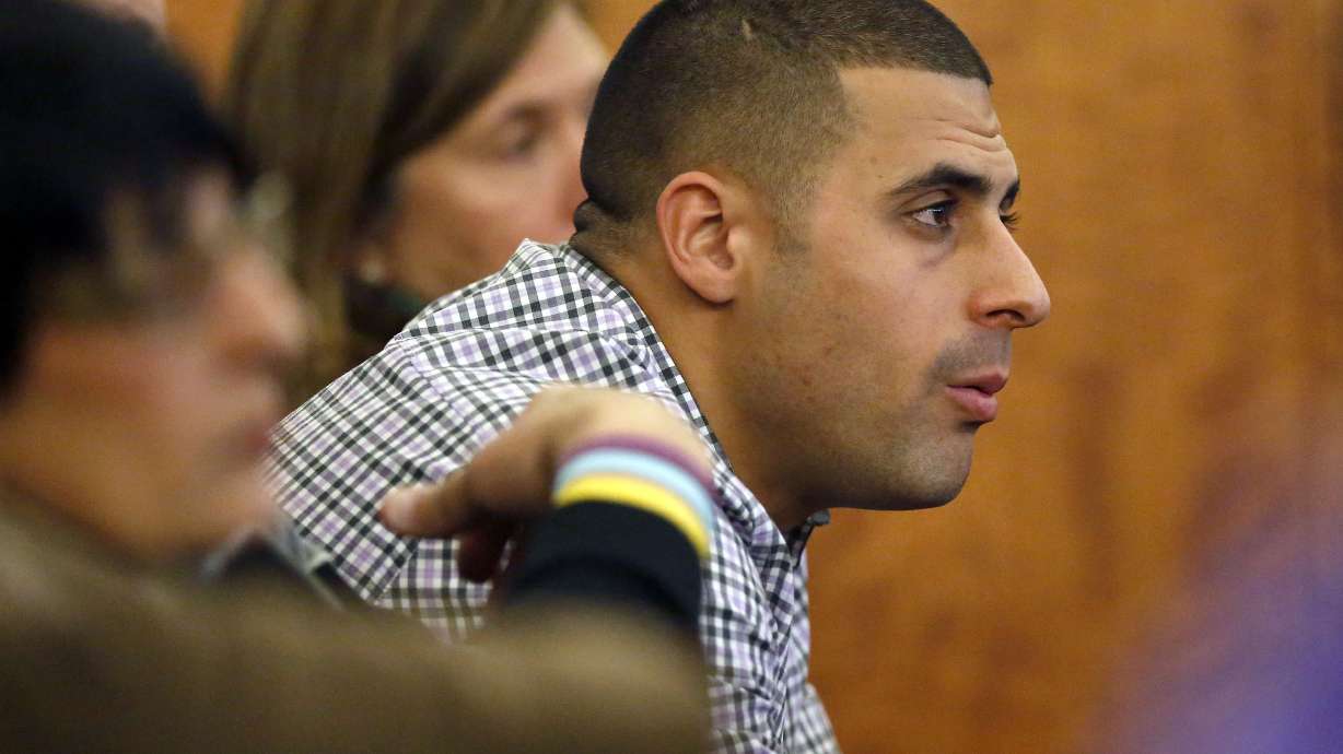 FILE - Dennis Hernandez, brother of former New England Patriots NFL football player Aaron Hernandez, watches during his brother's murder trial on Jan. 29, 2015, in Fall River, Mass. Former UConn football player Dennis Hernandez is behind bars after a witness told police she believed he was planning a school shooting. The 37-year-old, who went by DJ while playing for the Huskies as a quarterback and receiver in the mid-2000s, is due in court on Aug. 1 on charges including threatening.
