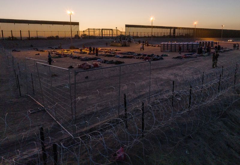 Migrants are seen gathered on the U.S.-Mexico border at sunrise after the lifting of Title 42 near El Paso, Texas on May 12, 2023. A U.S. federal judge on Tuesday blocked President Joe Biden's new regulation restricting asylum access at the U.S.-Mexico border.